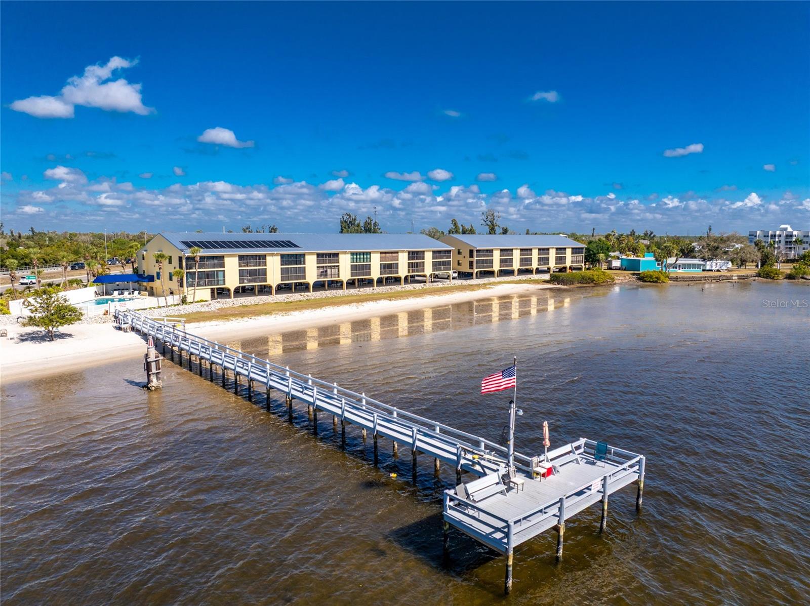 Open Waterfront Living | Panoramic Views | Turnkey Furnished | Fully Remodeled 2025. Experience effortless Florida waterfront living in this beautifully remodeled, turnkey furnished residence in Tarpon Bay, where an open layout and sweeping water views take center stage. From the moment you enter, the sightline draws you through the expansive living space to uninterrupted panoramic views of the Myakka River and Port Charlotte Harbor. The thoughtfully designed open floor plan seamlessly connects the kitchen, dining, and living areas, creating a bright, airy coastal retreat ideal for both everyday living and entertaining. The home is tastefully furnished in a refined coastal style, featuring a light, neutral palette with soft textures and natural elements. The living room offers comfortable, elegant seating anchored by a clean-lined media console and accent pieces that enhance the relaxed waterfront ambiance. The dining area showcases a charming coastal table with woven seating, perfectly complementing the space, while bar seating at the breakfast bar adds both function and flow. Sliding glass doors lead to the enclosed Florida room, offering flexibility to enjoy it open to the breeze or enclosed for year-round use. This space extends your living area while framing stunning sunset views over the water. The remodeled kitchen features warm wood cabinetry, quartz countertops and a spacious breakfast bar—all positioned to take advantage of the open layout and views. New appliances include a stove, microwave, dishwasher, and a convenient full-size stacked washer and dryer. Extensive 2025 upgrades include: Luxury plank flooring throughout, new interior doors and baseboards, updated lighting and ceiling fans, a new 3-ton A/C system, new hot water heater, hurricane impact windows and fresh interior paint. The spacious primary suite is a peaceful retreat with serene water views, furnished with a stylish queen bedroom set. The guest suite is equally inviting, also offering a queen bed and ensuite access—perfect for visitors. Additional highlights include two generous interior storage closets ideal for beach gear and everyday essentials. Tarpon Bay offers resort-style amenities including a heated pool, newly completed fishing pier with cleaning station, kayak storage, outdoor grills, private beach access, and under-building parking with ample guest spaces. The building also features a new metal roof (2023). Ideally located near Charlotte Sports Park, area beaches, boat ramps, and local dining and shopping, this move-in ready residence offers flexibility with hardly any rental restrictions—making it perfect as a full-time home, seasonal getaway, or investment opportunity. Open spaces. Endless views. Turnkey coastal elegance.