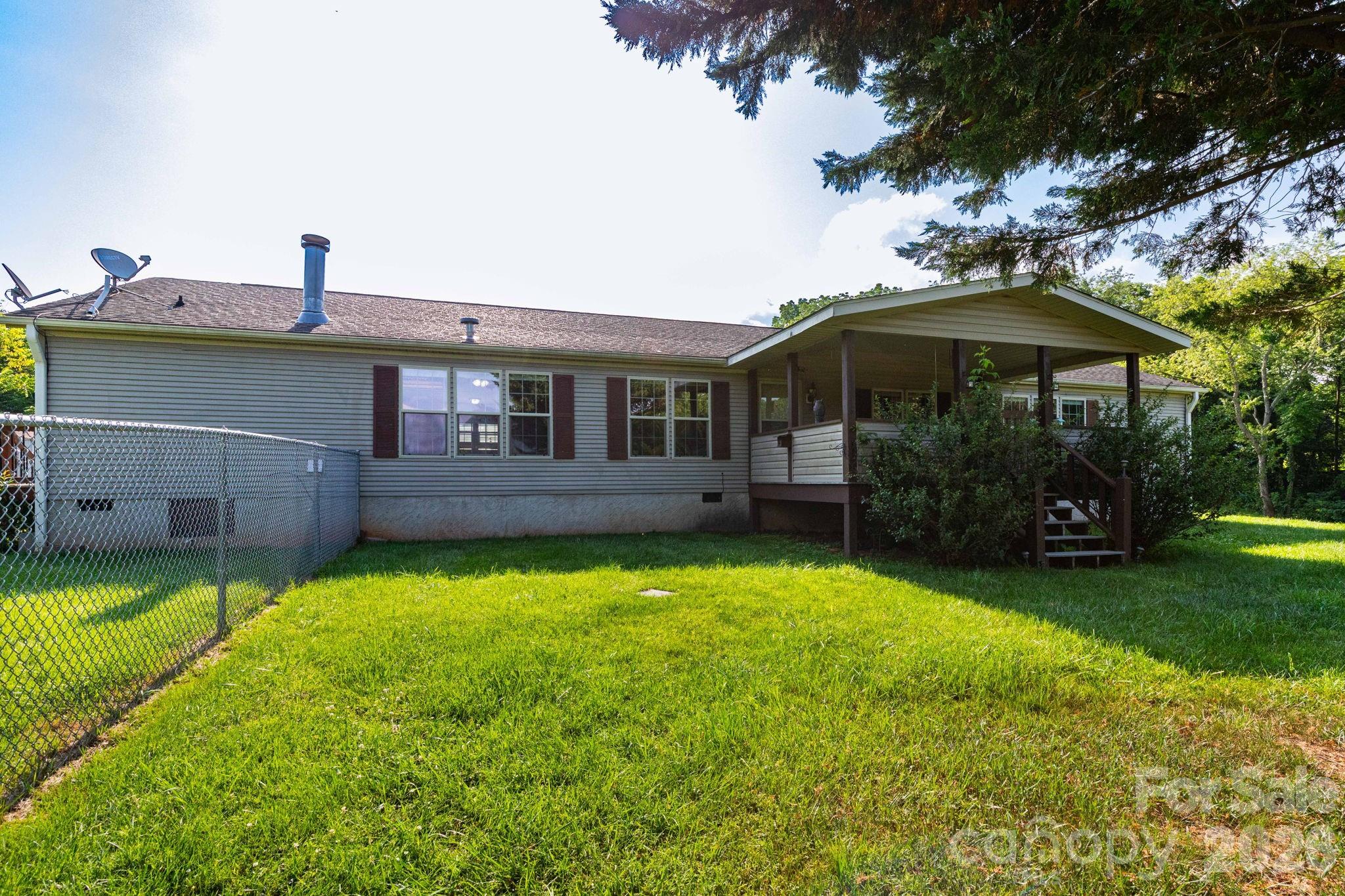 Welcome home to this spacious and well-maintained 3-bedroom, 3-bath manufactured home situated on a private 0.86-acre lot. Offering over 2,050 square feet of living space, this 2004 home features an inviting floor plan with both a living room and a separate family room, providing plenty of space for relaxing and entertaining. The updated flooring, newer appliances, and generously sized laundry room add to the home's comfort and functionality. Enjoy peaceful mornings and evenings from the screened-in porch overlooking the partially fenced yard, ideal for pets, gardening, or outdoor gatherings. Outside, you'll find ample storage with an 18' x 20' storage building as well as an additional metal storage shed. The property also offers both carport and driveway parking. With its private setting, spacious interior, and abundant storage, this property offers the perfect combination of comfort, convenience, and country living while remaining within easy reach of local amenities.