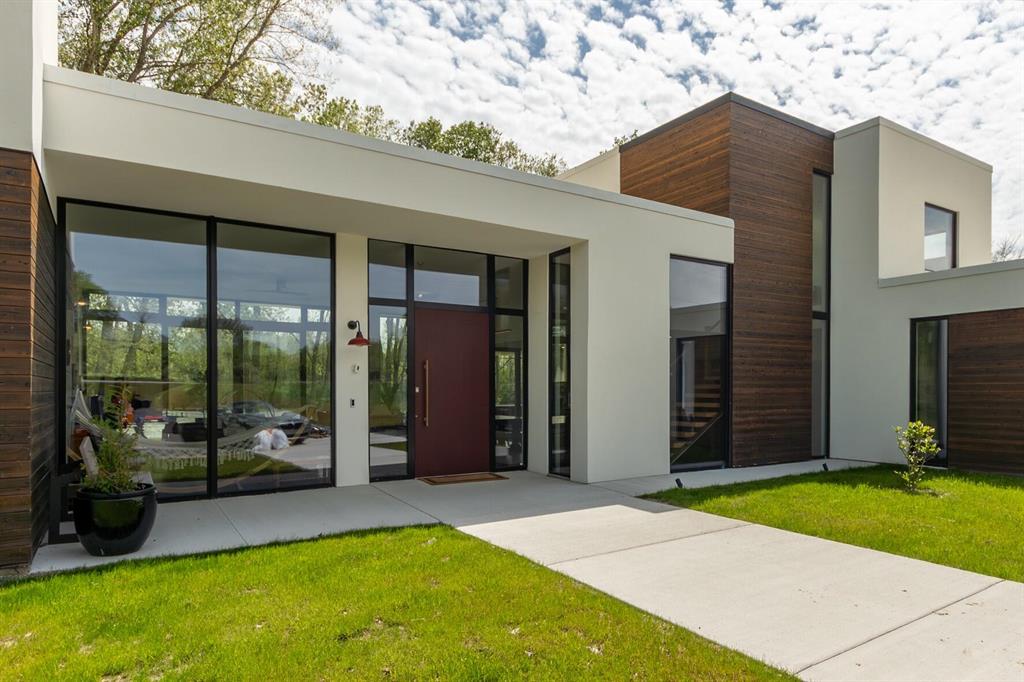 The BENEFIT of this property...This spectacular lakefront custom-designed home built with ALUPROF Triple pane Passive House certified (European and American standards).... Let us begin the basics: 4 to 5 Bedrooms, Master Suite, In-Law Suite, Ensuites, 4 Full Bathrooms, 1 Half Bathroom, OVER 3 Acres, direct private waterfront on 10-acre spring fed lake, Oversized 2 Car Garage with electric car chargers, nearly 4,000 square feet of stellar finished space, Ann Arbor Schools, Ann Arbor Mailing, open concept modern style.  Now the spectacular stuff... Air tightness to passive house level, Potential NETZERO and LEED Platinum certification, Ultra high R-value (30/60/90) insulation (R80-Roof, R90-Floor), Designed to take direct sunlight to heat the concrete and marble slab of the house during the winter months.  And there is so much more... All Steel Framing, Guardian wall panels - Structural insulated panels set in steel studs, Structural foam - 2 feet under the slab / 15" thick roof and 8" walls (reinforced steel), Swiss Air handler ERV system, Aluminum windows imported from Poland, Heat pumps with individual units for bedrooms, All bathroom sinks are equipped with an instant hot water supply, Heated and insulated 30' garage with two electrical automobile chargers, Bedrooms - Outside rolling shutters, Custom-designed and handmade woodworking around the house with white oak and walnut, pantry kitchen with dishwasher and prep area, Commercial Durolast flat roof with room for expansion, Marble flooring, marble shower walls and marble kitchen backsplash, Carlyle wood flooring, very rare Japanese charred wood siding, Commercial grade Stucco, Two Electric Car Chargers, Touchless faucet with instant hot water in every faucet.  Check out the high-end appliances: 54" La-Canche oven - Handmade in France (6 figures), Gaggenau 30" Column refrigerator, Gaggenau 24" column freezer, Gaggenau 24" column wine cooler, Bosch built-in expresso maker, Two dishwashers (Bosch and Gaggenau), Drawer microwave.  Additional OPTIONS: Heated front