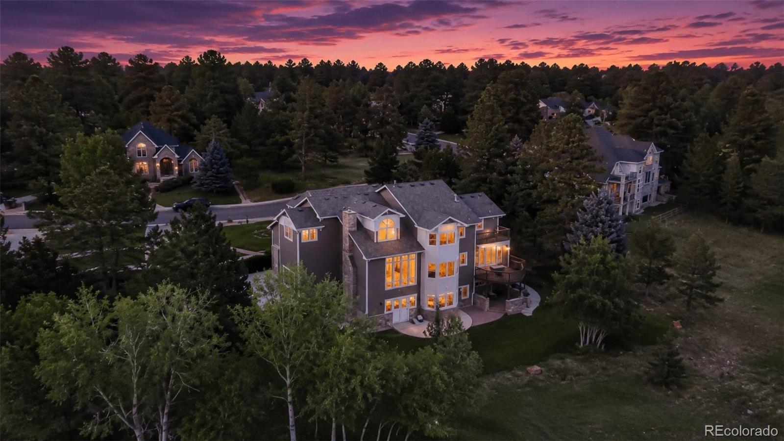 Experience elevated Colorado living at 7928 Towhee Road, a private luxury retreat where sophisticated design, exceptional craftsmanship, and breathtaking natural beauty converge. Nestled among mature trees that create a secluded sanctuary on three sides, this remarkable residence captures unobstructed Pikes Peak views from every level and offers a daily connection to Colorado's abundant wildlife.Extensively reimagined with a commitment to quality and timeless elegance, nearly every space within the home has been thoughtfully transformed. At its heart, the designer kitchen showcases custom R.D. Henry cabinetry, quartz countertops, premium new appliances, bespoke lighting, and refined finishes curated for both everyday living and entertaining.The primary suite is a true retreat, featuring rich marble tile, a beautifully remodeled fireplace, and an exquisitely updated bath. Updated secondary bathrooms, a redesigned executive office with custom built-ins, new flooring, custom lighting, and a fully remodeled powder room continue the home's elevated aesthetic. The walkout basement featuring gorgeous French doors, offers exceptional flexibility, including a dedicated sound-reduction room ideal for a theater, studio, fitness space, or private retreat.Recent improvements include a new roof, interior and exterior paint, new A/C condenser, water heaters, Quiet Drive garage door openers, composite decking, professional landscaping, and smart HVAC and irrigation controls.Adjacent to the iconic Colorado Horse Park and surrounded by the area's equestrian lifestyle, residents also enjoy access to Bayou Gulch's 318 acres of open space, trails, parks, playgrounds, and recreation. Rarely does a home combine this level of refinement, privacy, and spectacular mountain views in such an exceptional setting. Schedule your private showing today and discover the extraordinary lifestyle that awaits!