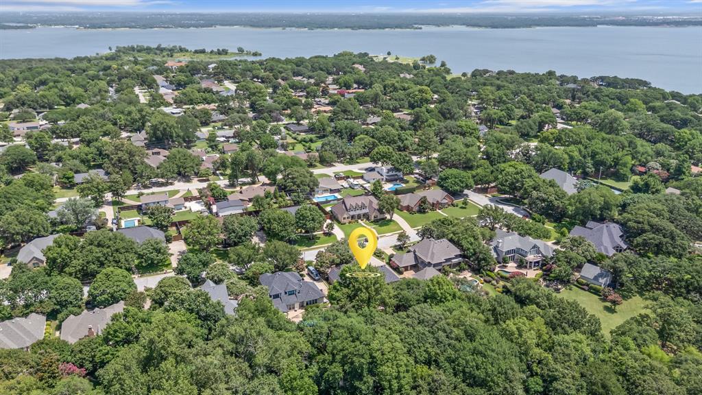 Hurry on this stunning custom home just minutes from Lake Grapevine. Sitting on over half acre and located on a quiet tree lines street in highly sought after Steiger Estates in Grapevine. This home features 4 bedrooms, 3 full baths and a 3 car garage. All bedrooms located on the first floor. It is loaded with updates, high end finishes, built in features, and generous storage throughout!  Living Room overlooks serene backyard and opens to kitchen with large center island, gas cooktop, double ovens, granite countertops, breakfast bar and breakfast room. Dry bar and built in beverage bar! Master suite with room for sitting area and bath with dual sinks, garden tub and an spacious closet.  Second level game room with built in cabinets, and 23x15 floored attic space.  Truly beautiful backyard with lovely patio with stamped concrete and pergola perfect for relaxing after a busy day or entertaining.  So many special touches including circle drive, lovely hardwoods, custom built ins, soft close cabinets, epoxy garage floor. This home has everything you have been looking for plus near parks and trails! Located minutes from historic downtown Grapevine which features shopping, dining and entertainment. DFW Airport and easy access to major highways all close by.