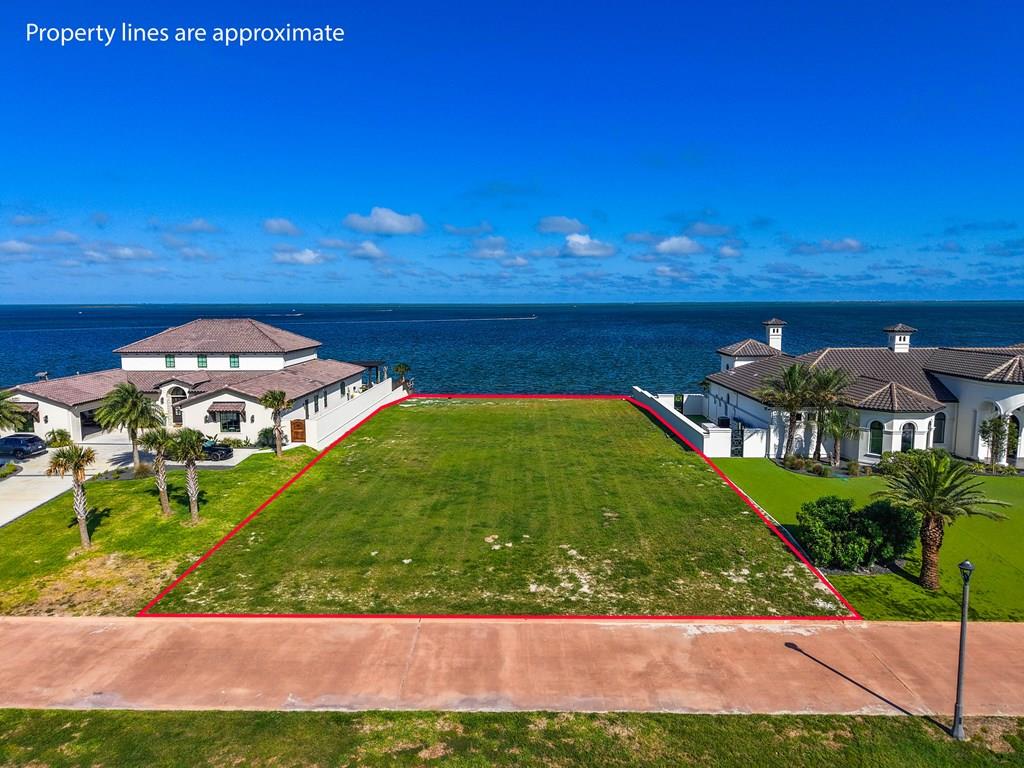 Enjoy breathtaking waterfront views from this exceptional homesite in the exclusive gated community of La Buena Vida. Spanning approximately 0.56 acres with over 100 feet of waterfrontage, this premier property offers unobstructed views of South Bay, Redfish Bay, and the Intracoastal Waterway, with no homes across the street ensuring additional privacy and tranquility. Ideally located between Rockport and Aransas Pass, you'll enjoy direct access to some of the finest fishing on the Texas Coast. Owners enjoy access to the private neighborhood marina with a dedicated boat slip, while the lot itself offers the opportunity to build a private pier, creating the perfect setup for boating and fishing enthusiasts. Included with the sale are stunning custom home plans for an approximately 3,500-square-foot residence, allowing the next owner to skip the lengthy design process and begin building right away. Whether you're seeking a full-time residence or a private coastal getaway, this rare offering combines unparalleled views, direct water access, and the opportunity to create a truly one-of-a-kind waterfront home in one of the Coastal Bend's most desirable communities.