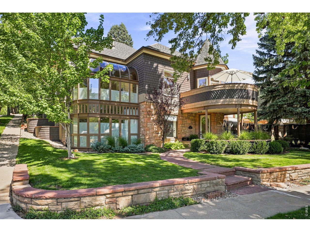 Perched atop the crest of one of Mapleton Hill's most desirable streets, 403 Mountain View has it all. Historic character, strong architecture and an unbeatable in-town setting give this home a presence that is immediately distinctive. Inside, original details are balanced by thoughtful updates, creating rooms that feel warm, collected and beautifully livable. A dramatic glass atrium brings exceptional light into the heart of the home and captures seasonal and mountain views, while generous living and dining spaces flow easily for both everyday life and entertaining. A private lower-level entrance creates an independent living arrangement with two bedrooms, a separate bath and generous living space, ideal for extended family, long-term guests, an au pair, or simply added privacy and flexibility. The primary suite is equally considered, with a beautifully appointed bath and steam shower, while three generous in-wall/eave storage areas on the upper level provide valuable additional storage.Outside, the home really comes into its own. Multiple porches and patios create places to gather, dine and unwind throughout the day, while the private pool and waterfall bring an effortless resort-like quality to the setting. An 8' x 10' garden/storage shed tucked behind the pool adds convenient additional storage. Seller has also secured City of Boulder Landmark Alteration Certificate approval for a proposed one-car garage and enclosed mudroom-an unusual and valuable opportunity in historic Mapleton Hill. Flatiron views, mature landscaping, an electric gate and 220V car charging station add both character and convenience. There is also one off-alley parking space at the rear of the property.And the location is next to impossible to beat: just moments from Pearl Street, downtown restaurants and shops, neighborhood cafes, Mt. Sanitas and some of Boulder's best trails. This is Mapleton Hill living in its most complete form-private, connected, architectural and distinctly Boulder.