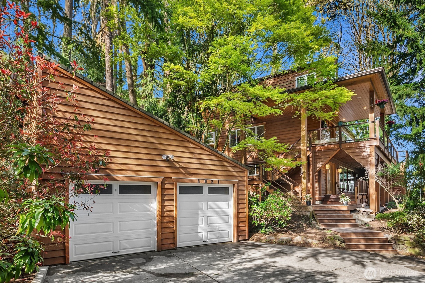 This one-of-a-kind property is a masterpiece of craftsmanship, thoughtfully designed to create a sense of timeless beauty. With a unique blend of natural woods that add warmth and character, the property has a serene setting for privacy and is perched high for views to Lake WA. Towering windows flood the home with natural light. The handsome birch floors lead you throughout the airy, open main level. Grand and impressive, the sleek kitchen is the heart of the home. Upstairs, the primary suite connects to a loft and sunroom - a wonderful design for activities like work-from-home, crafts, reading, yoga. With multiple view decks, there is no shortage of outdoor spaces to enjoy the natural surroundings. Well loved & beautifully maintained.
