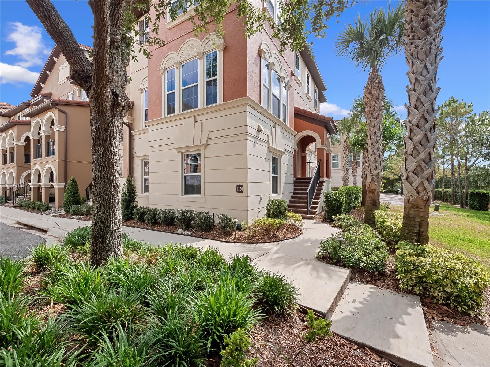 Under contract-accepting backup offers. Welcome to luxury living in the guard-gated community of Fountain Parke! This stunning 4-bedroom, 3.5-bathroom townhome spans 2499 square feet across three beautifully designed floors. A coveted end unit, this Ashton Woods "Torino" model features abundant natural light with its 10’ ceilings and multiple windows. Throughout the home, upgraded lighting, fixtures, and cabinetry reflect timeless elegance. Wide plank engineered hardwood floors anchor the second and third levels, and the smooth finish walls and ceilings are painted to perfection. This versatile home offers two primary suites, one on the first floor and another on the third, providing exceptional flexibility. The first-floor suite offers complete privacy, featuring a full bath, walk-in closet, and plenty of space, making it ideal for a guest bedroom, in-law suite, home office, or even a home theater. The third-floor primary suite is a true retreat, with a spacious bedroom and custom walk-in closet. The en-suite bathroom is equally impressive, with a dual vanity and spacious walk-in shower. This level also includes two generously sized bedrooms sharing a Jack-and-Jill bath, as well as a conveniently located laundry room. The second floor serves as the main living and entertaining space. The kitchen, which features stainless steel Viking appliances and a large island, is bathed in natural light and flows seamlessly into the dining room, sunroom, and balcony. Adjacent to the kitchen, you and your guests will enjoy a bright and airy living room, complete with custom floor-to-ceiling bookcases, a built-in entertainment center, and in-ceiling surround sound. The monthly HOA dues include water, irrigation, and landscaping, ensuring a hassle-free lifestyle. Fountain Parke residents enjoy a host of resort-style amenities, including a pool, hot tub, fully equipped gym, tennis and pickleball courts, putting green, dog park, toddler play area, and a clubhouse with billiards and card tables. Conveniently located with easy access to I-4, SR 417, and SR 429, this home is close to a variety of shopping and dining options. Downtown Orlando is just 25 minutes away, while Daytona Beach and New Smyrna Beach are under 45 and 60 minutes, respectively. Iconic attractions such as Disney World, Disney Springs, SeaWorld, and Universal Studios are all within a one-hour drive.