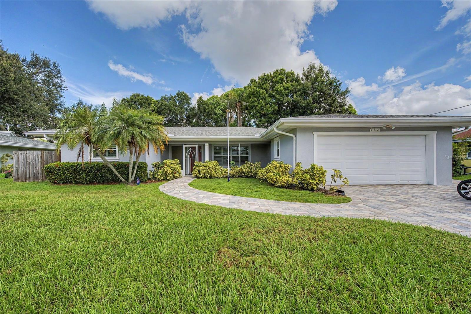Welcome to this beautifully maintained three-bedroom, 2.5-bath home in a desirable, golf-cart-friendly Dunedin neighborhood with no HOA and in a non-flood zone. Conveniently close to downtown Dunedin, the Pinellas Trail and Our Lady of Lourdes Catholic Church, this home reflects exceptional pride of ownership. The seller has proactively addressed the property’s maintenance, including hiring an engineer to replace piers showing even hairline cracks and inspect the remaining piers, which were determined to be structurally sound. The same engineering firm also completed chemical grout injection to level the patio. Notable updates and features include the roof (2019), HVAC system (2016), water heater (2016), electrical panel (2016), refrigerator (2016), dishwasher (2024), washer (2023) and garage door (June 2026). Plantation shutters enhance the main living areas, while all bedrooms feature wood blinds. An enclosed back patio and spacious backyard provide plenty of room to relax, entertain or create your own outdoor retreat. With its immaculate condition and convenient Dunedin location, this thoughtfully cared-for home is ready to welcome its next owner.