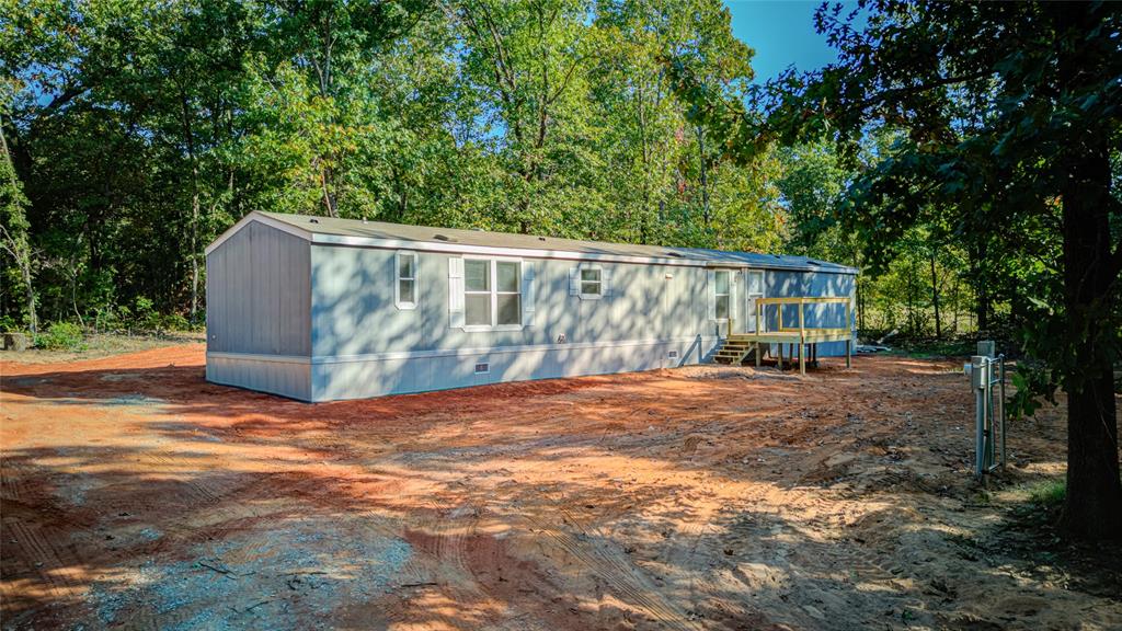 Nestled in the Oak trees you will find a neat, clean, and updated 2013 mobile home.  3 bedrooms and 2 baths.  Primary bath has a separate shower and tub with lots of storage and closet space.  New well and septic, new hot water heater,Kitchen has a nice breakfast bar and is open to the living and dining area. Split bedroom plan.  Fully furnished with Washer/Dryer, dishwasher, stove, microwave, and refrigerator. Central heat and air. You will love the new carpet and vinyl flooring. Also new skirting and vents.  Front and back porches rebuilt.  Buried electric and conduit ran for fiber with OEC.  Warranties come with new items.  Super location just North of Highway 9 about a mile.  Easy access to Norman, Shawnee, Thunderbird Casino, Minutes from Lake Thunderbird.  Easy access to 1-40 and Tinker AFB.  Literally 4 minutes to Harps Grocery, Sonic and Dollar General.  The land behind is Indian Tribal land so it is very quiet  and serene.  Everything was done by Norman codes.  Electrician that hooked up the power and the septic registered it with DEQ.  Nice places for a vegetable and flower garden. Plenty of room to build a nice shop.