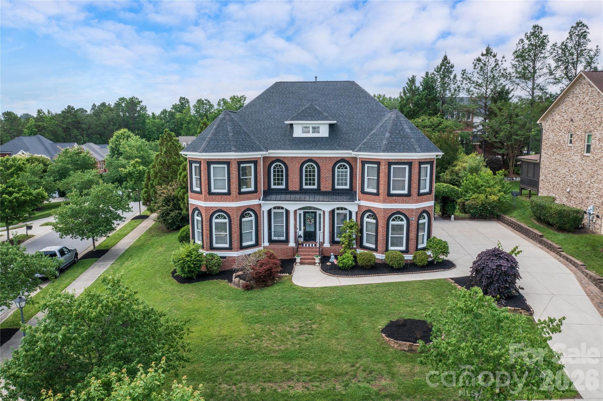 Nestled in the highly sought-after Skybrook community, this stunning full-brick home offers exceptional curb appeal, an elegant open floor plan, and luxurious upgrades throughout. A grand two-story foyer welcomes you with abundant natural light and beautiful Brazilian cherry hardwood floors throughout the main level. The thoughtfully designed layout features a desirable guest suite on the main floor, along with formal living and dining spaces accented by tray ceilings and classic wainscoting. The gourmet kitchen is a chef’s dream, showcasing quartz countertops, a spacious center island, stainless steel appliances, an impressive 8-burner gas cooktop, double ovens, and a bright breakfast area overlooking the backyard oasis. The dramatic two-story great room features a cozy gas log fireplace and creates the perfect gathering space for everyday living and entertaining. Retreat to the spacious owner’s suite complete with a tray ceiling, three large closets, and a beautifully remodeled spa-inspired en-suite bath with dual vanities. Upstairs you’ll find generously sized secondary bedrooms, additional bathrooms, and a convenient laundry room, while the third floor offers versatile media and recreation spaces ideal for movie nights, gaming, or a home gym. Step outside to your own private resort-style backyard featuring a sparkling custom saltwater pool, stunning 18x18 gazebo, tranquil koi pond, and beautifully designed entertaining spaces perfect for hosting year-round. New roof in 2024, new water heater, new a/c, whole house water filtration system, surge protector, epoxy garage floor, CPI security and camera system, and much more! Ideally located in Huntersville, near parks, dining, shopping, and entertainment. This exceptional home also offers convenient access to I-485, I-85, and Concord Mills. Residents enjoy optional community amenities including a pool, tennis courts, and golf course. This is luxury living at its finest — a true must-see!