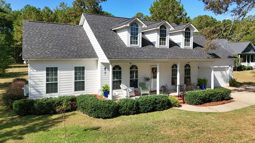 This is the perfect home. With a lake view and privileges, a new roof, a new back deck and sitting on 1.34 acres. Picture yourself on the front porch, sipping sweet tea while taking in the peaceful bird songs and stunning views of Lake Riverside. Step inside to find hardwood floors and an inviting open layout with flexible spaces including an owner's choice room, formal dining area, and a cozy living room enhanced by vaulted ceilings and a wood-burning fireplace. The split bedroom design ensures privacy, while the primary suite features a walk-in closet, dual vanities, soaking tub, separate shower, and direct access to a spacious back deck overlooking the expansive yard. Recent updates include a new roof, a new back deck with covered grilling area and the home also offers a convenient laundry room and 2-car garage. With access to the scenic 100-acre lake and close proximity to all that Thomasville, GA has to offer, this home perfectly blends charm, comfort, and modern convenience.