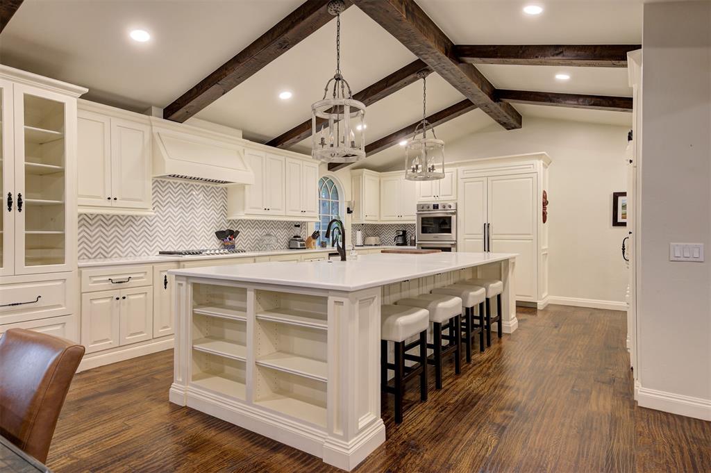 This unique and beautifully remodeled home is a true must-see! As you arrive through the custom electronic steel gate, you'll be welcomed by a gorgeous estate nestled on just over 2 acres of private, tree-filled land. From the outside you will find 2 brand new HVAC units, new impact level 4 roof, new sprinkler system, new well pump, whole house Generac generator, and security camera system. Step inside to discover hand-scraped wood floors flowing throughout the home, offering warmth and elegance at every turn. The residence features two fully remodeled bathrooms with heated flooring, a 15' x 15' concrete safe room, and an additional concrete room perfect for a playroom, office, or gym. Expansive living room with a grand fireplace and large glass doors opening to the backyard. In the kitchen you will find a 12’ island, an ice maker, and a separate bar area – perfect for entertaining. The upgrades and remodeling were done by Brent Cornman, a well-known & high quality contractor in the area. Out back, you will find an entertainers dream. A stunning pool that has been resurfaced and retiled. A beautiful gazebo with a wood burning fireplace that sits between the most beautiful mature trees. This thoughtfully designed, one-of-a-kind property is truly a rare find—you won’t want to miss it!