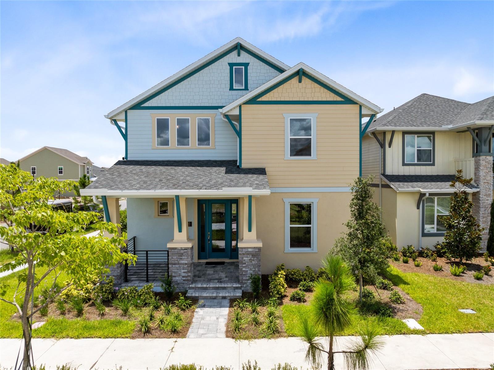 One or more photo(s) has been virtually staged. This custom brand new, never-lived-in Laureate Park home sits on a prime corner lot facing a landscaped mew and walking path. Built in 2025, it features coastal-style curb appeal with stone columns, a covered front porch, and bold teal double doors that make a statement from the start. Inside, you’re welcomed by light luxury vinyl floors, oversized windows, and an open-concept layout filled with natural light.

The kitchen is equipped with stone countertops, under-cabinet lighting, built-in stainless steel appliances, a sleek vent hood, and a walk-in pantry. It opens to spacious dining and living areas, perfect for entertaining. The main floor also includes two guest bedrooms with a Jack & Jill bath, a private office with French doors, and a laundry room.

Upstairs, a generous loft provides extra space for a second living area, media room, or playroom. The primary suite offers peaceful views and includes one walk-in closet and a spa-like bath with dual sinks and a glass-enclosed shower. Two additional bedrooms and a full bath complete the second floor.

The covered rear patio leads to a detached 2.5-car garage with extra storage space, a paver walkway, and low-maintenance landscaping.

Laureate Park isn’t just a neighborhood—it’s a vibrant lifestyle. Enjoy the Aquatic Center, resort-style pools, LP Fit gym, and 44+ miles of trails. Located in prime Lake Nona, minutes from Medical City, the VA hospital, Nemours, dining, and shopping. Close to major highways, Orlando International Airport, and the USTA National Campus. Easy access to Orlando’s top theme parks and beautiful Florida beaches. This home blends space, luxury, and community in a sought-after location. Experience elevated living—schedule your private tour today!