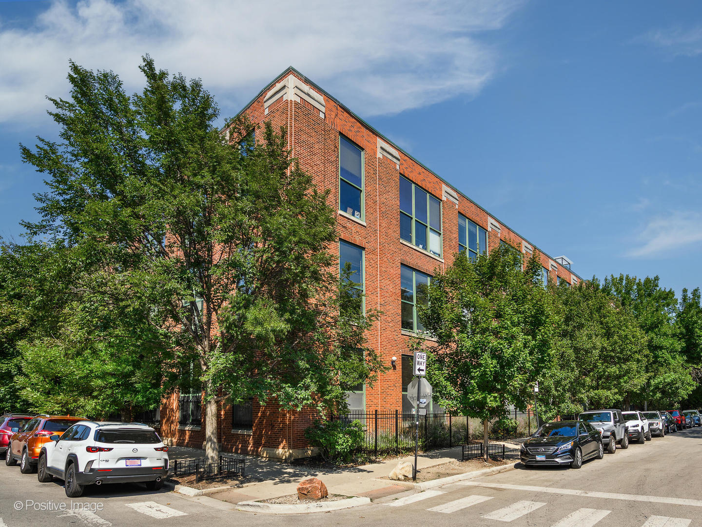 Step inside this one-of-a-kind, impeccably renovated 3 bedroom, 2 bathroom brick and timber loft in the beloved Brau House Lofts, where soaring ceilings, dramatic design, and sun-drenched spaces create the ultimate blend of style and luxury. Perfectly positioned in the heart of Logan Square, this home offers the ideal balance of neighborhood charm and vibrant city living. Flooded with natural light from three exposures, the expansive living and entertaining space features a custom bar with built-in keg, sleek fireplace, and oversized windows that frame the open layout beautifully. The chef's kitchen stuns with a custom wood island, Taj Mahal quartzite countertops, high-end Bosch appliances, and incredible cabinet storage, flowing seamlessly into the dining area and living room for an ideal entertaining setup. The spacious primary suite boasts a generous walk-in closet and a brand-new, spa-like bathroom with dual vanities and an oversized tile shower. Two additional large bedrooms include a guest suite with ensuite bath and highly customized closet build-outs. The building offers elevator access and a shared rooftop deck with sweeping city views. A lofted unfinished space adds endless potential, perfect for a home office or incredible extra storage. Exterior parking space included. Step outside and experience all that Logan Square has to offer, from The 606 Trail to Colectivo, Revolution Brewing, Sushi Taku, and some of the area's best dining, coffee shops, and nightlife, everything is right at your doorstep.