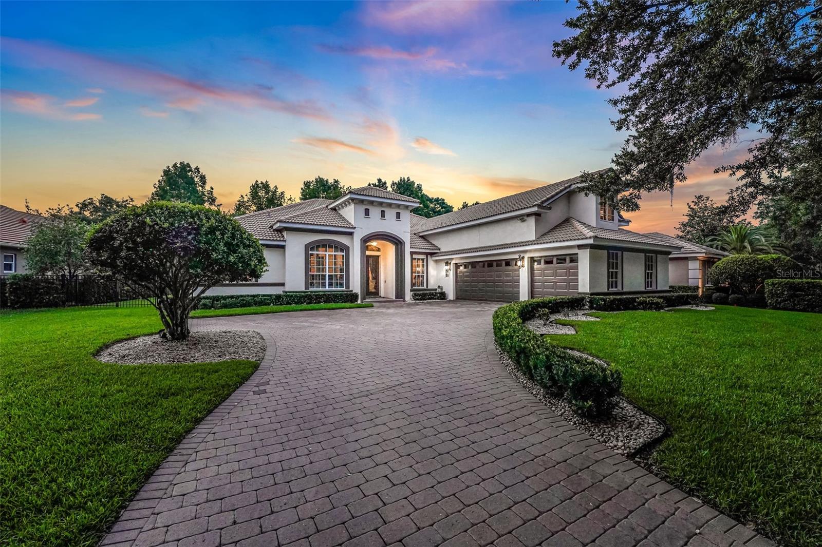 Perfectly positioned in the sought-after, guard-gated golf community of Alaqua Lakes, this 4-bedroom, 4-bathroom home with office/den and SHIMMERING POOL w/summer kitchen offers tranquil wooded views and exceptional privacy. Enjoy impressive curb appeal at this move-in ready and meticulously maintained residence, featuring an open, light-filled floor plan with multiple French doors and large windows throughout. The spacious primary suite extends the full length of the home and includes an oversized walk-in closet with custom-built-ins. A second-floor loft provides additional living space and can easily serve as a fourth bedroom or flexible bonus area. The newly renovated kitchen with new cabinetry, countertops, and Thermador appliances is ideal for entertaining, seamlessly flowing into the main living areas and out to the beautifully landscaped backyard. A natural gas Generac whole-house backup generator(installed in 2022) ensures worry-free living during inclement weather. Enjoy Florida living at its finest with a summer kitchen overlooking your fully fenced yard, expansive greenery, open pool, and spa—perfect for gatherings or quiet relaxation. Don’t miss this opportunity to own a stunning home in one of Central Florida’s most exclusive communities. As a resident of Alaqua Lakes, you'll have access to a unique 7-acre community park with an open-air pavilion, multipurpose field, tennis courts, and more—all just minutes from top-rated schools, upscale shopping, dining, business centers, and major highways. This property may be under audio/visual surveillance.