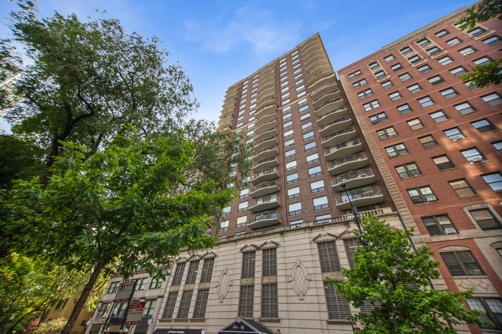 Welcome to this spacious and light-filled 2 bed, 2 bath condo in the heart of Chicago's historic Gold Coast. Located in the sought-after B tier, Unit 8B features a desirable split-bedroom layout, updated lighting, and a large east-facing balcony overlooking tree-lined Dearborn Street. The open-concept living and dining areas flow seamlessly into an all-white kitchen with black granite countertops. The primary suite includes a walk-in closet with custom organizers and a stylish en-suite bath. The second bedroom offers flexibility for guests or a dedicated home office. Both bathrooms have been beautifully renovated with modern vanities and include walk-in showers with Toto, Kohler, and Hansgrohe fixtures. New hardwood floors in the bedrooms add a light, airy feel throughout, and the newly added in-unit washer/dryer is tucked neatly into a utility closet for maximum convenience. Unwind outside on the private balcony with sweeping eastern views towards the lake, large enough to easily accommodate a grill + dining set. 1250 N Dearborn is a full-amenity building with 24-hour door staff, on-site management, a fitness center,  and a recently updated rooftop deck with panoramic city views, lounge seating, pergola, grill, and fire pits. Valet parking is available in the attached garage for an additional fee. The unit includes a storage cage, access to bike storage room for additional fee, and up to two pets (25 lb. max per pet). Enjoy an unbeatable location just steps from Oak Street Beach, the Lakefront Trail, Lincoln Park, top-rated dining, shopping, and public transit via bus or the Clark/LaSalle Red Line.