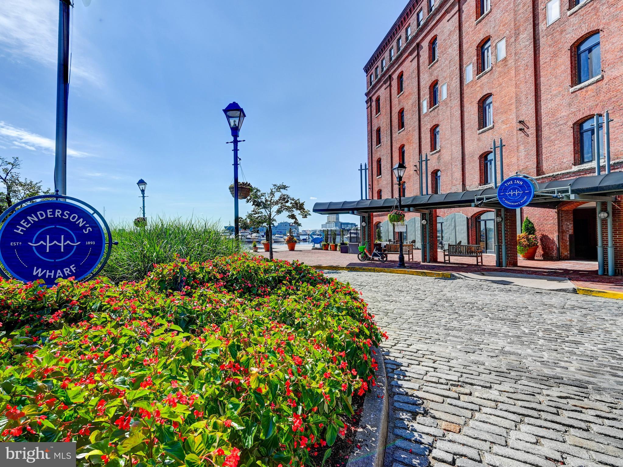 Newly renovated, this charming studio apartment in Henderson's Wharf offers a delightful blend of comfort and convenience. Step inside to discover an inviting open floor plan that seamlessly connects the kitchen and living area, perfect for relaxation or entertaining. Hardwood floors add warmth, and the well-equipped kitchen includes essential appliances such as a dishwasher, refrigerator, microwave, and stove. Enjoy serene views of the courtyard and lush gardens from your windows, with new motorized blinds creating a peaceful retreat. The building offers excellent amenities, including a fitness room, meeting space, and party room, to enhance your lifestyle. With 24-hour security and a welcoming lobby desk, the community prioritizes safety and comfort. Located in a vibrant community, you'll appreciate nearby parks, local shops, and easy access to public services. The Patapsco River is just a stone's throw away, offering scenic walks and recreational opportunities. Experience the charm of Henderson's Wharf-your new home awaits!