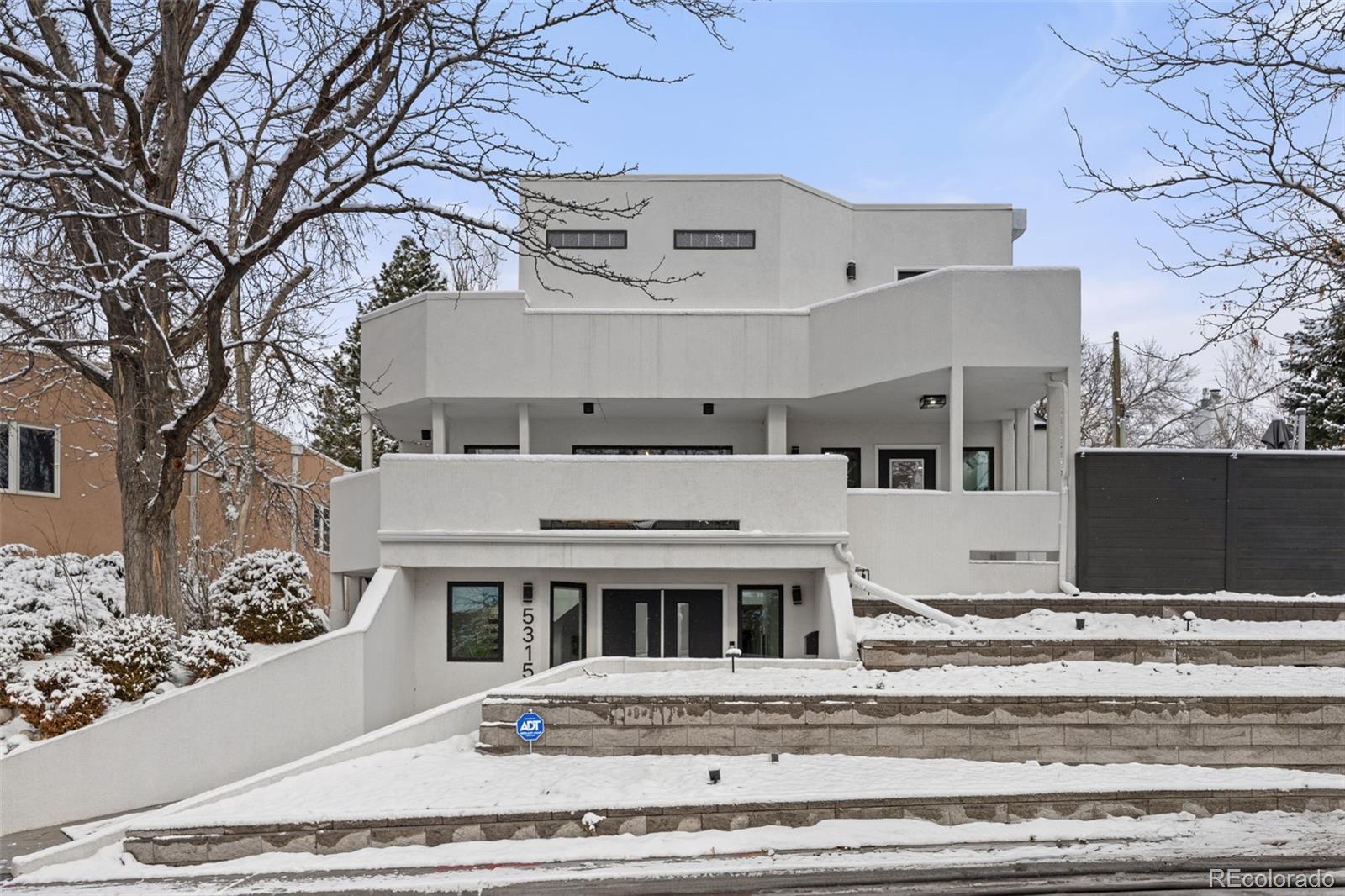 Stunningly remodeled and flooded with natural light, this south-facing 4-bedroom, 5-bath residence in South Hilltop offers an exceptional blend of modern design and warm, intimate living. Its incredibly versatile three-level, open-concept floor plan is designed to adapt to a wide variety of lifestyles—equally ideal for hosting large gatherings or enjoying quiet everyday moments.The mezzanine level features expansive living and dining areas that open to one of three distinct outdoor spaces, creating seamless indoor–outdoor flow. A spacious first floor offers impressive flexibility: use it as additional living quarters, a guest suite plus an office, fitness area, creative studio, playroom, or whatever best suits your needs.Upstairs, the luxury primary suite feels like a private retreat with its own beverage/coffee bar, a spa-inspired five-piece bath, and a serene private deck with sweeping views. Three additional bedrooms and two laundry areas throughout the home provide convenience and comfort at every turn.With modern finishes, thoughtful spaces, and panoramic vistas, this South Hilltop home delivers elevated living in one of Denver’s most desirable neighborhoods—all while allowing buyers to tailor the space to their unique lifestyle needs.