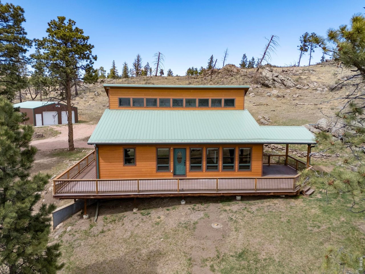 Stunning mountain home in Rist Canyon on a gently rolling 10 acre lot dotted with evergreens and rock croppings. Vaulted ceilings, open floorplan and abundant natural light from transom windows in the great room and floor-to-ceiling windows offering a 180 view. Enjoy over 800 sq ft of wrap-around deck including a covered portion stubbed for a propane grill or fireplace. Gourmet kitchen features soft-close cabinets, rolling shelves, double oven, bay window and granite counters. Main level includes three bedrooms plus a 100 sq ft bonus loft-perfect hideaway for kids or adults. Walk-out basement, new carpet and wood floors, water softener with cistern backup, Generac generator. Two insulated Cleary outbuildings on concrete pads, heated and electrified with garage door openers (two 9' doors and one 12'x12' door) and loft storage. A rare combination of privacy, views and ready-to-enjoy mountain living.