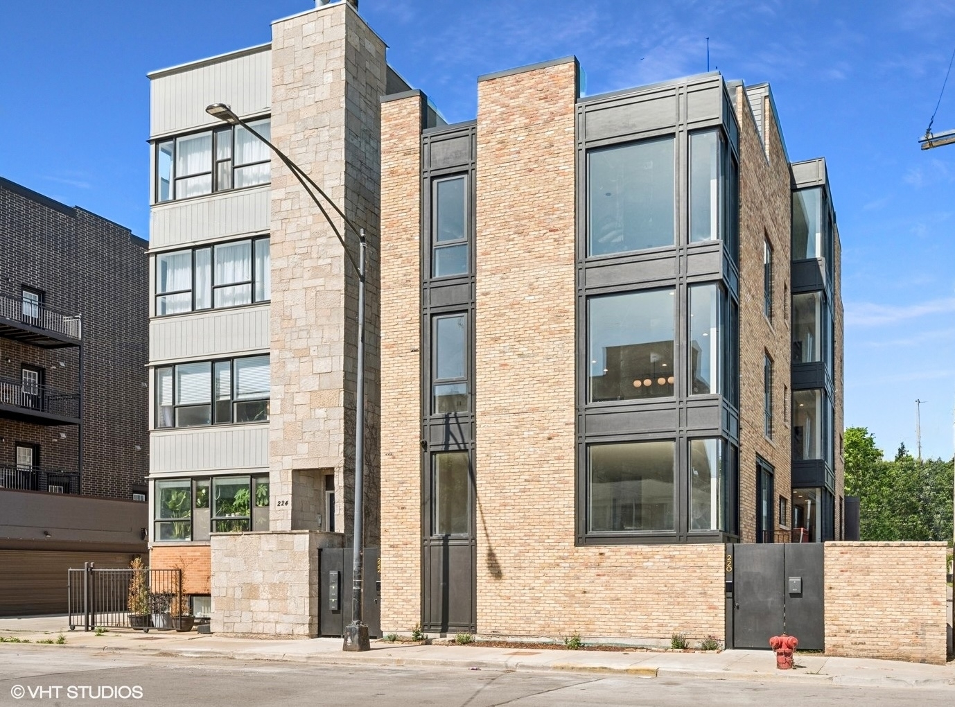 Beautiful blend of salvaged Chicago brick & sleek/modern black cement composite paneling & large steel windows in this high 2nd floor & sunny new construction 1,502 sqft 3BD/2.5BA home w/downtown views from a spacious living & dining room featuring wood floors & multiple extra large & tall windows including a column-free NE-corner & south-facing window!  Modern kitchen features multiple deep & tall pull out drawers for incredible kitchen storage & pull out trash/recycling cabinet.  SS appliances incl exterior-vented range hood, induction range, counter-depth fridge, built-in microwave, LED undercab lighting & a large island w/seating for four.  King-sized primary bedroom w/large fully organized walk-in closet w/room to get dressed inside & while laying in bed thanks to a column-free corner glass window you enjoy a peek at the downtown skyline!  En-suite bath has heated floors, a large double quartz vanity w/four 4' storage drawers, lighted mirrors, a window for natural light in the middle & a walk-in rain shower w/wall to wall shower niche.  Two queen-sized secondary bedrooms share a bathroom w/two 4' storage drawers.  This carefully designed home also features a walk-in laundry room with side by side W/D along w/folding & hanging stations.  At the back door there's a separate mud room w/coat closet - a great place to kick off shoes and hang coats w/out seeing them!  Finally, if you're looking for outdoor space this home features a 29'X20' private & sunny garage roof deck w/exterior lighting, water & electric - perfect for entertaining or living outside during the warmer months OR to become a green-thumb!  One garage space w/electrical charging capability comes w/this home.  Quick 0.3 mile walk to the Blue Line, Pete's Fresh Market, events at the United Center & soon to begin 7 billion dollar 1901 Project master plan which aims to create new park land, a 6,000 seat music venue, over 9,000 residential units, 1,300 hotel rooms, 660,00 sqft of office & another 670,000 sqft of new destination retail surrounding the United Center.  PREFERRED LENDER - ASK FOR MORE INFORMATION.  OPN HSE SAT & SUN 11AM-1PM!