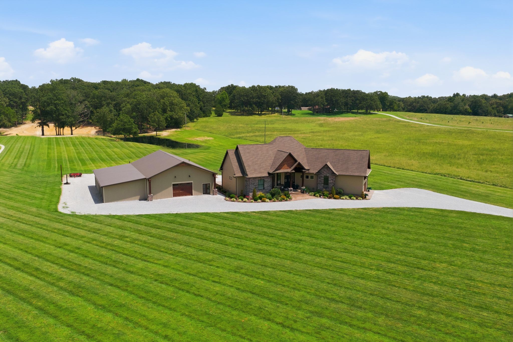 This home makes a statement! A rare opportunity to own 152± acres in the heart of Dickson, just minutes from downtown and approximately two miles from shopping, restaurants, and everyday conveniences. This custom-built estate offers the perfect combination of luxury, privacy, and endless possibilities.The 3-bedroom, 3.5-bath home features an open floor plan with soaring vaulted ceilings, exposed wood beams, a stunning floor-to-ceiling stone gas fireplace, and a chef's kitchen complete with custom cabinetry, stainless steel appliances, and a hammered copper farmhouse sink. An office provides the ideal work-from-home space, while the main-level primary suite offers a spa-inspired bath with a soaking tub, tiled shower, dual vanities, and spacious his-and-her walk-in closets. Upstairs, you'll find a large bonus area with one room perfect for entertaining and another that could easily serve as a fourth bedroom, home gym, hobby room, or additional office. The encapsulated crawl space includes a dehumidifier for added efficiency and peace of mind. Home offers a tankless water heater. Outdoor living is designed for entertaining with a spacious covered patio, additional open patio, and a custom stone outdoor kitchen featuring a built-in KitchenAid natural gas grill. Beautiful wood ceilings accent both the front and rear porches, while stamped concrete, wrought iron doors, and professional landscaping complete the home's impressive curb appeal.The matching 40' x 60' shop includes a full bath with tiled shower, laundry area, walk-in closet, and a finished flex room ideal for a guest suite, office, or workout space.The property features multiple ponds, established food plots, and abundant wildlife, making it ideal for hunting, recreation, farming, or simply enjoying the beauty and privacy of Middle Tennessee. Properties of this caliber rarely become available. see mls  3251340 land only