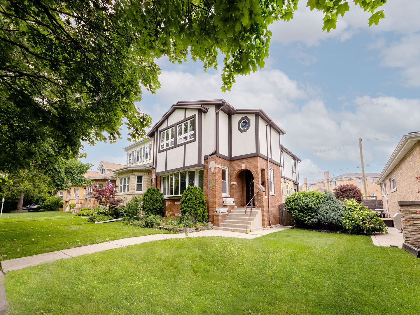 Welcome home to an impressive, 2-story home nestled on a double lot in the heart of Edison park, which is one of Chicago's most sought-after neighborhoods!  Walk into a very spacious living room area accentuated with blonde hardwood floors, recessed lighting, a charming brick fireplace and a massive bay area window, which allows natural sunlight to pour into your home.  The living room effortlessly flows into a formal dining room featuring another large bay area window for that added burst of light.  Notice how the original baseboard trim, window trim, solid oak doors and crown molding add elegance and charm to this home.  It is an ode to Chicago.  Equally important, the first floor offers a rare first floor bedroom along with an updated full bathroom decorated with a floating vanity, a quartz countertop, impeccable tile work and a stand up shower.  This home continues to flow easily into a large, well-equipped kitchen with solid oak cabinetry, stainless steel appliances and granite countertops; there is also a breakfast room parallel to the kitchen for added functionality.  And, yet, off the rear of the home, a large mudroom with a sliding glass door opens up to a private backyard: it is perfect for barbecues, perfect for letting kids play and/or perfect for your pets.  The first floor is intelligently designed.  And so is the second floor!  A welcoming second floor foyer area leads to four additional bedrooms and two additional full bathrooms.  Each bedroom is surprisingly spacious with ample closet space.  There is a common, full bathroom nestled between these bedrooms and a full-fledged second floor laundry room, which just makes washing and drying clothes practical and convenient.  Wait until you see the primary bedroom.  It is huge!  It features a cathedral ceiling, gleaming hardwood floors, a skylight and several windows that simply add to its natural brightness.  The primary closet is generous in size too.  The primary bathroom features a tub, a stand-up shower, another skylight and a purposeful vanity.  It is impressive.  Then head to a sprawling unfinished basement and decorate it to your preferences.  This home is dialed into top-rated Ebinger Elementary, acclaimed Taft High School, Olympia Park, the Kennedy Expressway, CTA bus stops, the Blue Line and it is just minutes away from downtown Edison Park's nightlife. Show and sell.  Easy to show.