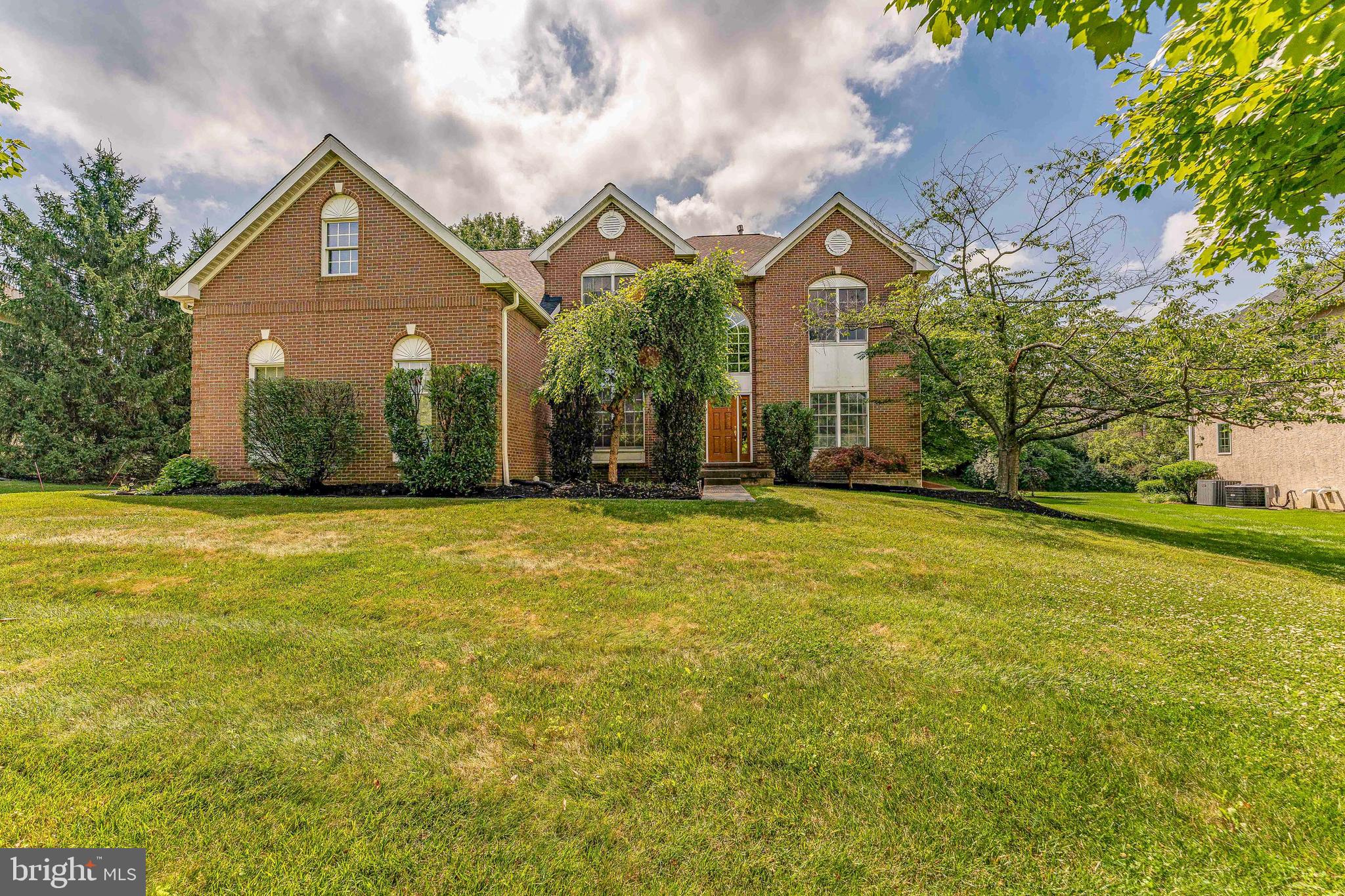 Welcome to 2069 Saint Andrews Drive, a beautifully appointed 4-bedroom, 2-full-bathroom, 2-half-bathroom single family home in the highly sought-after Greens of Waynesborough community of Berwyn, located within the award-winning Tredyffrin-Easttown School District. Set in a planned neighborhood with mature trees and nearly two miles of sidewalks, this home offers a bright open floor plan, a dramatic two-story foyer with hardwood floors, a three-car garage, upgraded lighting, built-in surround sound, home surveillance with motion detection and Ring cameras, and a new roof installed in 2022 for added peace of mind. The main level is designed for both everyday living and entertaining. The formal living room features hardwood floors, crown molding, chair rail, recessed lighting, and an open columned entry into the dining room. The dining room continues with hardwood flooring, detailed trim, and a triple rear window that brings in natural light. The family room offers a warm gathering space with hardwood floors, recessed lighting, built-in speakers, and a gas fireplace with a brick surround and wood mantel. The upgraded kitchen is a standout, featuring beautiful quartz countertops, stainless steel appliances, a gas cooktop, double wall ovens, a built-in Keurig refrigerator, a large island with seating, tile backsplash, a walk-in pantry, and a bright breakfast area. Whether you are preparing everyday meals or hosting family and friends, this space offers the layout, storage, and finishes buyers are looking for. Additional main-level highlights include a home office with heated travertine tile flooring, a convenient half bathroom, and a mudroom with two storage closets. The laundry room includes tile flooring, LG front-load washer and dryer on pedestals, and direct access to the three-car garage. Upstairs, the expansive primary suite provides a true retreat with a spacious sitting area, abundant natural light, and a giant walk-in closet. The remodeled primary bathroom features separate vanities, a glass step-in shower, and a separate whirlpool spa tub, creating a comfortable and spa-like setting. Three additional spacious bedrooms each offer carpeting, ceiling fans, ample closet space, and natural light. A full hall bathroom completes the upper level. The finished lower level is one of the home's most impressive features and is truly an entertainer's dream. This premium space includes built-in surround sound, dual TV connections, eco-friendly cork flooring, programmable upgraded lighting, and a half bathroom. The wet bar features granite countertops, while the kitchenette includes stainless steel appliances for added convenience. A walk-in wine closet with cedar wine holders creates a custom touch, and an additional room provides excellent storage or flexible space for hobbies, seasonal items, or household organization. Outside, a stylish brick patio overlooks a large backyard framed by mature landscaped trees, creating a peaceful setting for outdoor dining, relaxing, or entertaining. The community setting adds even more appeal, with sidewalks throughout the neighborhood and a school bus stop just steps away next to the adjoining home. Conveniently located a short distance from Amtrak and SEPTA stations, the Upper Main Line YMCA, Valley Forge National Historical Park, King of Prussia Mall, local shopping, restaurants, and major commuter routes, this home offers both privacy and accessibility. With its premium finished basement, custom wine cellar, 2022 roof, three-car garage, upgraded kitchen, surveillance system, and exceptional location in the Tredyffrin-Easttown School District, 2069 Saint Andrews Drive is a rare opportunity in The Greens of Waynesborough.