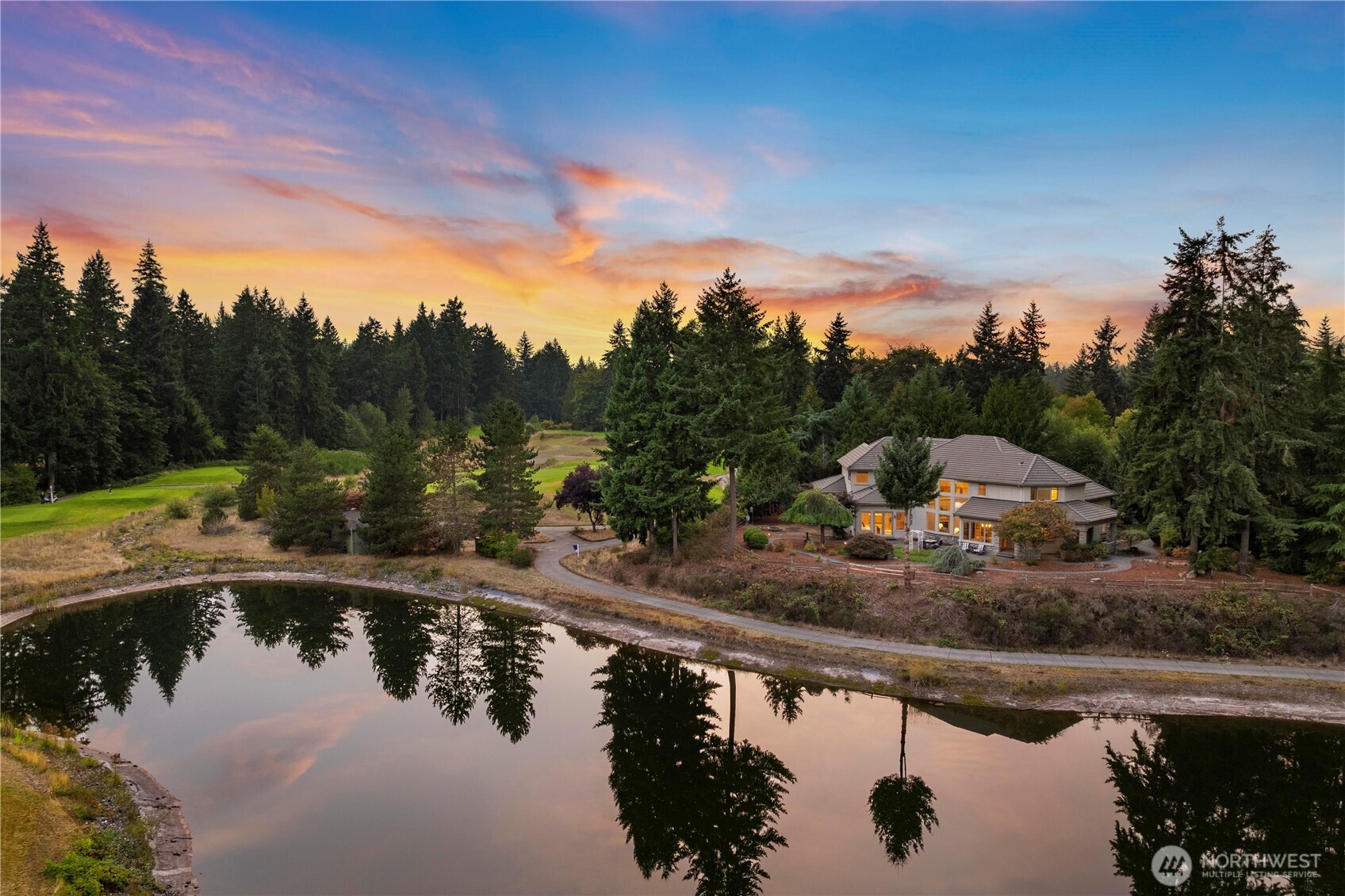 Behind the gates of Washington National Golf Club, a treelined drive leads to this former Street of Dreams home on a private half-acre overlooking the 17th fairway and reflective ponds. Beyond the patio, manicured fairways unfold against a quiet backdrop of evergreens. Inside, cherry hardwoods and crisp millwork lend warmth and elegance, while the Viking-appointed kitchen with double ovens, prep sink and wine cooler anchors gatherings. The main-floor primary suite offers a cozy fireplace, coffered ceilings and a spa-inspired bath. Upstairs, 3 en-suite bedrooms, a large bonus room, and dual staircases add versatility, complemented by a 3-car garage with golf cart bay. Here, craftsmanship and setting define a lifestyle both rare and refined.
