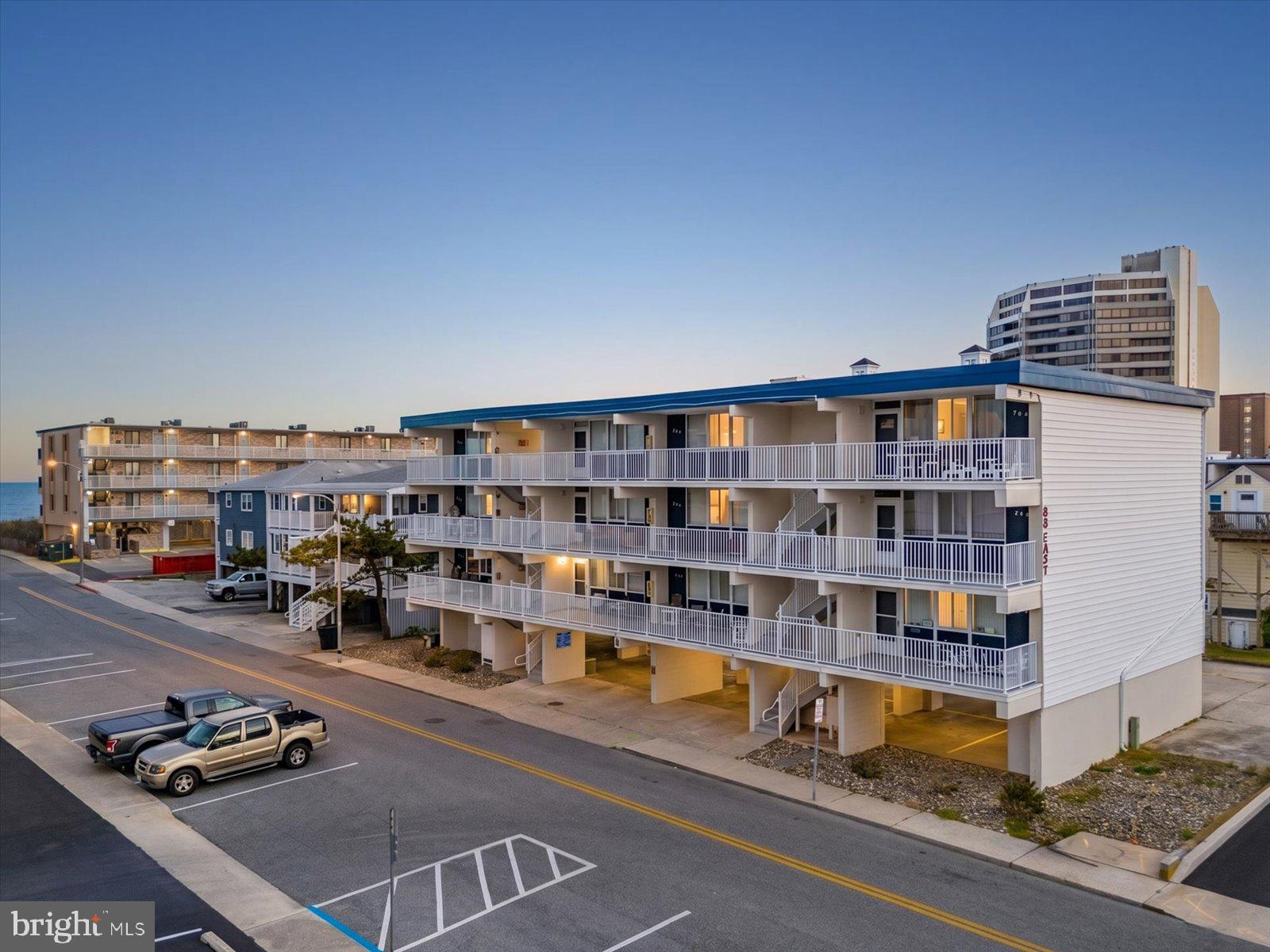 Charming 2BR/2BA Ocean Block Condo in Midtown Ocean City on 88th Street!! A bright and inviting 2-bedroom, 2-bathroom coastal condo tucked away on the ocean block in the heart of Midtown Ocean City — one of OC's most convenient and sought-after locations. Just a short walk to the beach and surrounded by Ocean City's best dining, shopping, and entertainment, this turnkey retreat is the perfect summer escape!Step inside to a light-filled, open-concept living and dining area finished with easy-care tile flooring throughout the main living spaces — ideal for sandy feet and salty days at the shore. The classic white kitchen offers full-size appliances, generous cabinet storage, and a functional layout that flows effortlessly into the dining nook and living room, making entertaining a breeze. Tasteful coastal furnishings and a soft beach-inspired color palette give the entire space a warm, vacation-ready feel.Both bedrooms are comfortably sized and offer plush carpet underfoot for a cozy, restful retreat at the end of the day. The primary bedroom features ample closet space and its own flat-screen TV, while the second bedroom provides flexible sleeping arrangements for guests or family. Two full bathrooms add everyday convenience, and the in-unit stacked washer and dryer means more time enjoying the beach and less time on chores.The highlight of the home? Your private covered balcony — the perfect spot to sip your morning coffee, catch ocean breezes, a view of the ocean, and unwind to the sound of the surf just down the street.Whether you're searching for a coastal getaway, an investment property, or a place to call home year-round, this Midtown OC condo delivers on location, comfort, and value. Schedule your private showing today — BeachLife Ocean Block!!