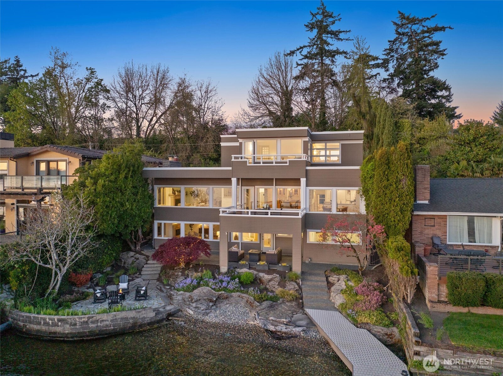 Tucked along sought-after Lake Avenue West, this extraordinary legacy property boasts 60’ of prime southwest-facing no-bank waterfront & unparalleled views of Seattle, Bellevue, and the Olympic Mountains. Watch sunsets, sailboat races, and moonlit reflections from nearly every room. Fresh new paint, carpet, and engineered hardwood floors elevate the classic finishes & abundant natural light throughout. The 3 bed, 3 bath home offers a flexible layout perfect for everyday living or entertaining, with room to expand. The expansive 1,300 sq ft dock—the largest on the street—features a rebuilt, grandfathered h-shaped slip that accommodates a 50’ yacht and jet ski lift. Just minutes from Downtown Kirkland, this is lakefront living at its finest.