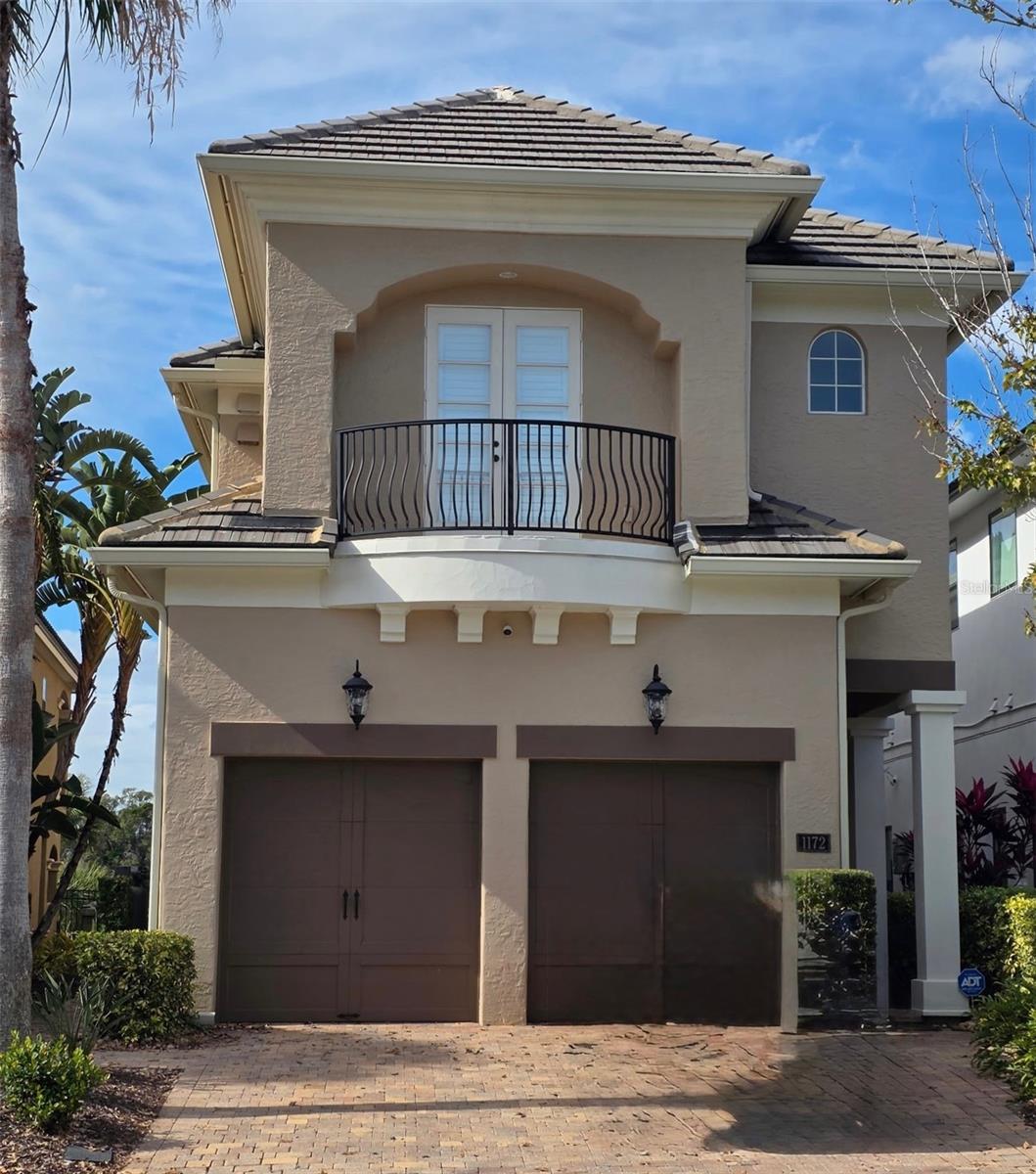 Transferrable Reunion Membership Available. You have to check out this custom Reunion Resort residence originally built as a model home by Hannigan Homes loaded with details and upgrades that truly set it apart from the crowd. This home features an amazing rotunda that flows into the open and spacious living and dining area. The high 12-foot ceilings white millwork set this home apart from the others.  The home provides the perfect space to entertain with a built-in wet bar on one side and butler’s pantry on the other, all flowing naturally into the off-white kitchen where the custom cabinetry accommodates the high-end appliances, including new Wolfe oven and microwave, new Bosch dishwasher with extra quiet motor. From the kitchen, spread out into your comfortable family room with floor-to-ceiling sliding PGT doors overlooking the pool and golf course. Open these doors and drop down the New High grade MagnaTrack HURRICANE Proof retractable screen to enjoy a true indoor/outdoor experience any time of the year on your private lanai with fireplace and full summer kitchen. The Pool system has been upgraded to Salt Water and the whole system has been renovated. Heading to the second floor – either via the solid wood staircase or in the fully maintained and serviced private elevator – there is an open loft that leads to the elegant primary suite. Amazing details such as tray ceiling, crown molding and custom woodworking, the Primary suite offers a private en-suite bath with a coffee station and refrigerator built-in, a spacious shelf-lined closet and its own balcony for a private view of the nightly sunsets. There is another bedroom with its own en-suite bathroom upstairs, along with two additional bedrooms that share the third bath. Laundry is easy with an upstairs laundry room. Upgrades abound throughout the home – all tile and luxury flooring, remote-controlled blinds in the family room and primary suite, attic foam insulation keeps the attic the same temperature as the house, central vacuum system.The home has SONOS throughout for your entertainment and enjoyment. NEW Top end ADT home security system with interior multiple panels and exterior cameras monitoring of all entry points.New Wi-Fi high-power garage door openers, New Lighting fixtures inside and out, New ceiling fansInterior and exterior was fully painted within last two years along with Extended driveway and pool pavers.$10k Culligan water softener and filtration systemThis home is located in Reunion Resort, an amazing community spanning 2300 acres, offers an array of amenities for every lifestyle. With three iconic golf courses, including those designed by Palmer, Watson, and Nicklaus, as well as the world headquarters of the Leadbetter Golf Academy, this resort is a golfer's paradise. Located just minutes away from the renowned Disney Parks and within close proximity to Florida's finest beaches, this location offers endless opportunities for entertainment and relaxation. Within the resort, you'll find a water park, 12 community pools, two golf pro shops, tennis courts, pickleball courts and a miniature golf course. Experience the lifestyle you've been longing for at this extraordinary property in Reunion, where luxury, sophistication, and unparalleled amenities await. Don't miss out on this exceptional opportunity!