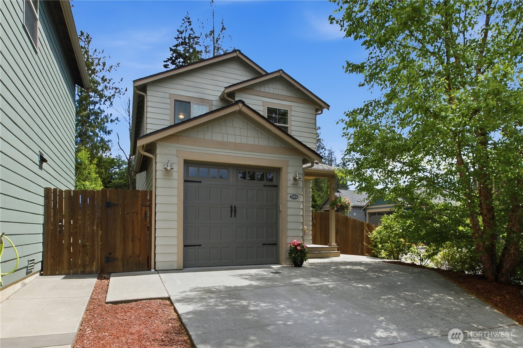 Private, Peaceful & Packed with Charm—This Poulsbo Beauty Has it All! Tucked away in a serene setting backing to a lush greenbelt, this delightful 2-bedroom, 2.25-bath Craftsman offers the perfect combination of comfort, privacy, & Northwest charm. From the moment you arrive, you'll appreciate the inviting curb appeal, thoughtful design & ample parking . Inside, you'll find a bright & welcoming floor plan & a beautiful kitchen featuring modern cabinets, granite countertops, stainless steel appliances, pantry & a cozy dining area. Fresh carpet, air conditioning & quality finishes throughout make this home move-in ready. Two generously sized primary suite bedrooms feature private full bathrooms & oversized walk-in closets, creating the ideal layout. The backyard is a true retreat. Enjoy summer barbecues on the stamped concrete patio, relax under the covered awning, or cultivate your favorite flowers & vegetables in the garden space. The fully fenced yard offers privacy, security & room for pets to roam freely with the convenience of a doggie run & door. Mature landscaping & the adjacent greenbelt create a tranquil outdoor setting that feels miles away from the hustle & bustle . Whether you're looking for your first home, downsizing without sacrificing comfort or seeking a low-maintenance property in a fantastic location, this Poulsbo gem delivers. Beautifully maintained & thoughtfully upgraded, it's the kind of home you'll fall in love with the moment you walk through the door!