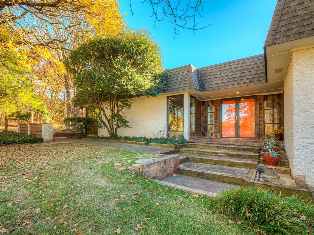 Spacious 4-bedroom, 2.5-bath home on a nearly one-acre lot in desirable Woodruff’s Tall Oaks Addition. Tucked away at the end of the neighborhood, this property offers exceptional privacy, mature trees, and a peaceful, park-like setting. The home features a well-designed, functional layout with contemporary and mid-century influences, highlighted by custom built-ins and abundant natural light throughout. Multiple living areas provide flexibility for both everyday living and entertaining, including a sunroom with sliding glass doors and clerestory windows that create an inviting indoor-outdoor connection while maintaining privacy. Custom built-in workspaces, cabinetry, and storage add versatility—ideal for a home office, hobbies, or additional living needs. A wet bar/kitchenette with a nearby half bath enhances the secondary living area, making it well suited for entertaining or guest use. With multiple courtyards and patio areas, this property offers a quiet retreat in an established neighborhood while remaining convenient to local amenities. A rare opportunity for buyers seeking space, privacy, and enduring architectural character. Some photos have been virtually staged and/or AI-generated for illustration purposes.