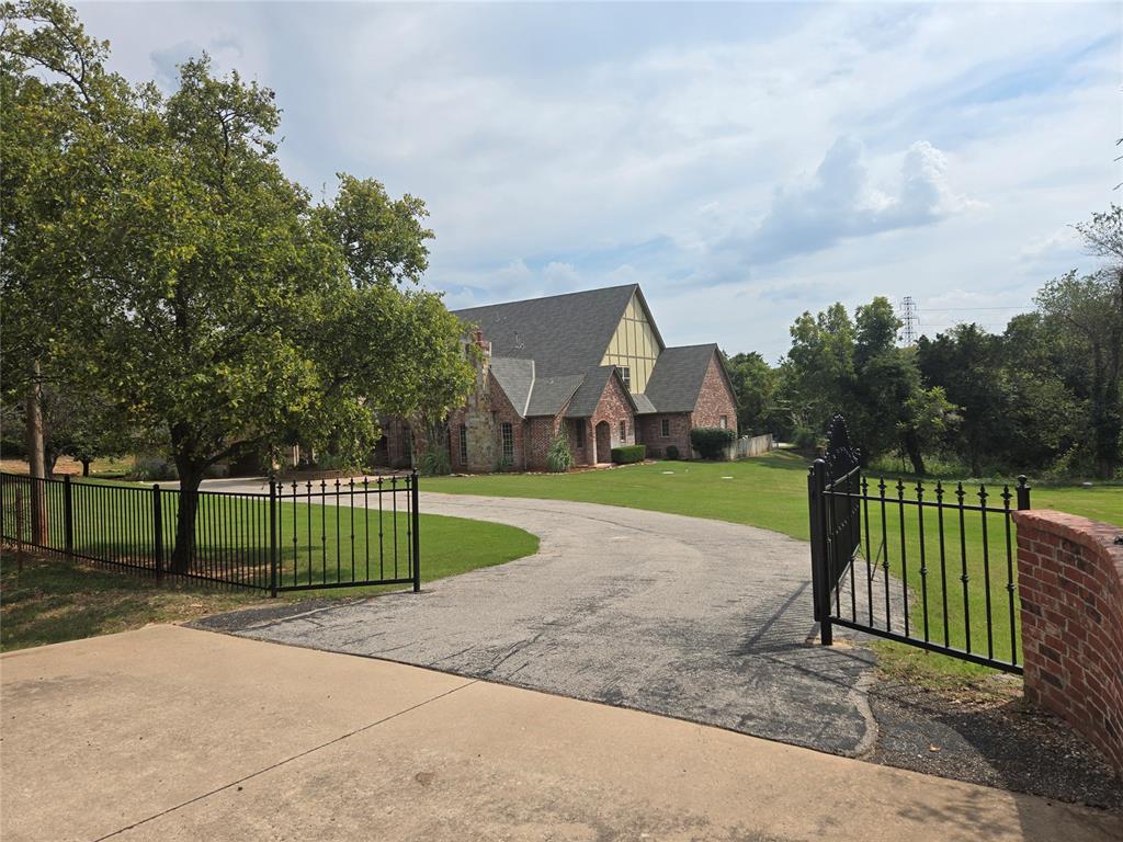 Lavish, OKC mansion! Gated entry. 6,184 sq ft(mol) situated on 7 acres(mol). Quick access to  I-35, I-235 & downtown OKC.  Amazing grand foyer featuring an impressive winding staircase. Two(2) master suites! 4 or 5 bedrooms, 5 1/2 bathrooms, 3 living areas, formal dining room plus a 5 car garage & portico. This home also features a gourmet kitchen with loads of counter top space, island with seating, stainless appliances plus an abundance of storage space. Great outdoor space including an inground pool, expansive open patio area plus a large covered patio with built-in grill and service bar. Other exterior features include wrought iron fencing, a circle driveway, natural waterfall, hiking trails, plus more. All nestled amongst 7(mol) beautiful & serene acres.