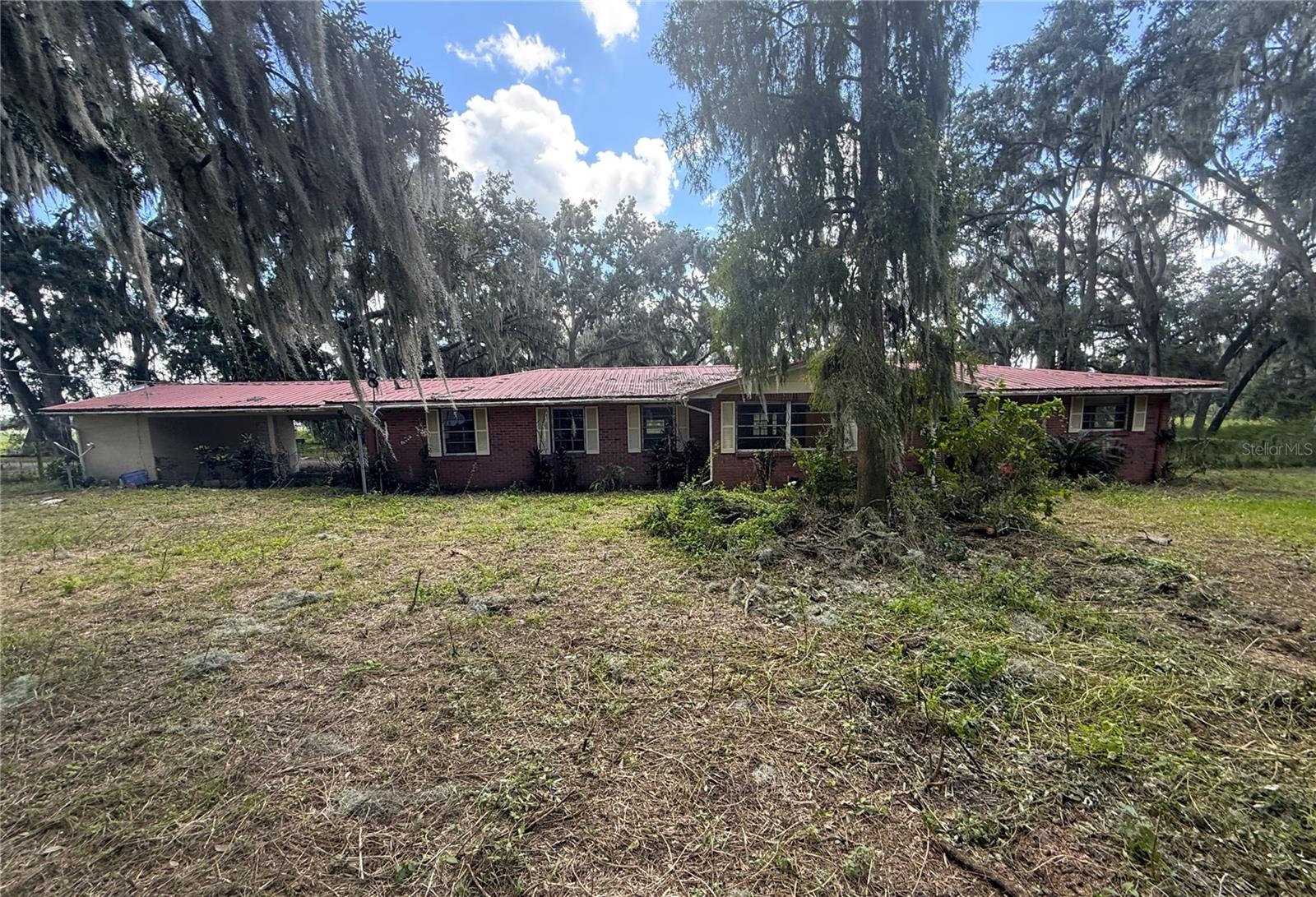 Enjoy the freedom and possibilities of 8 acres of agriculturally zoned property in Plant City! Offering 2,715 square feet of living space, 3 bedrooms, 2 bathrooms, and plenty of room to spread out, this property presents a unique opportunity for those seeking space, privacy, and country living. Step inside to a flex space and continue on into the heart of the home with a family room situated directly off the spacious dining room and kitchen - a pass through window from the dining room creates an open concept for entertaining. The kitchen includes ample counter and cabinet space and eat up counter height seating. French doors off the dining room lead to a bonus enclosed Florida room, featuring window A/C, provides additional flexible space to relax, entertain, or enjoy views of the surrounding property. Primary suite is just off the living space and includes built in closet, vanity, and shower/tub combination. The secondary bedrooms and full bathroom are just down the hall. Conveniently located in Plant City with access to major roadways, shopping, dining, and everyday essentials. Bring your vision and make this property your own. This property is best suited for a cash buyer. It's good to be home!