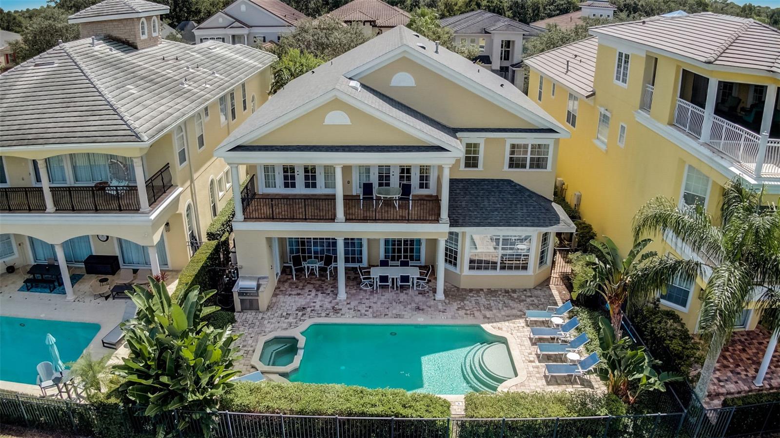 Ideally situated with sweeping views of the 6th, 7th and 8th holes of the signature Tom Watson golf course, this stunning residence is currently a successful SHORT TERM RENTAL - FULLY FURNISHED - 5 bedroom GOLF FRONT property located in the highly desired HOMESTEAD neighborhood of the REUNION RESORT. **Active transferrable MEMBERSHIP with property** Perfect as a main residence, second home or investment property. This home is TURNKEY and ready to enjoy. The open plan layout is well designed throughout lending itself to a spacious feel whilst providing plenty of relaxing as well as entertainment areas for family, friends and guests. From the living room with contemporary fireplace, fully equipped kitchen (together with both casual countertop seating for 8 as well as separate kitchen eating area for 8), a formal dining room which also seats 10, expansive MOVIE/GAME ROOM with reclining seating for 8 (with foosball, basketball, air-hockey table and playstation area), wet bar, study/desk area to a conversational coffee seating area. There is a large size bedroom on the ground floor and upstairs a further 4 bedrooms with 3 being ensuite and one Jack & Jill. The primary bedroom has direct access to the expansive balcony and the ensuite has a spa like infinity edge soaking tub with jacuzzi jets. Also on the second floor is an additional lounge seating area with double doors opening onto the balcony spanning the width of the home which OVERLOOKS THE POOL with spillover jacuzzi and picturesque GOLF COURSE VIEWS. With its enviable aspect, enjoy the sunshine either lounging out on the sizeable patio or seek shelter under the covered lanai. Home has outdoor pool half bathroom and patio shower. In the evenings basque in the beautiful Florida sunsets cooking on the built-in grill and dining in the outdoor area. Situated on a quiet CUL DE SAC, this residence is ideally located near the plentiful amenities of the Reunion Resort. **BOOKINGS TRANSFER if stay with existing rental manager.** Roof replaced in Oct 2022, a/c's 2021 and 2022, two tankless water heaters 2022. Property has stunning ACCENT FEATURES, modern lighting, fans, newer appliances and smart TVs in every room plus combo home theater/games room. With its three world class golf courses (designed by Arnold Palmer, Tom Watson and Jack Nicklaus), a golf academy, Clubhouse at The Bear’s Den, six onsite restaurants, twelve community swimming pools, a multimillion-dollar water park, six Har-True tennis courts, pickleball, bocce ball, volleyball, crazy golf, a playground, and full-service salon and spa, Reunion is only a couple of miles away from Walt Disney World Resort, SeaWorld and Universal Studios. Check out the video. Don't miss this gem, schedule your viewing today!