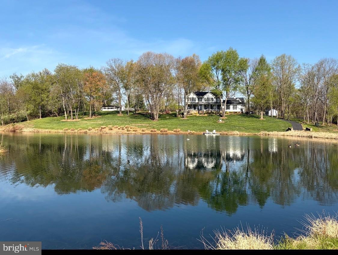 A full list of updates will be available in the documents section. Professional photography coming next week. Make sure to save the date for our open houses  from Friday-Sunday (6/5-6/7)!Tucked away at the end of a quiet cul-de-sac in the sought-after Ashley Springs community in Philomont, this extraordinary custom estate offers a rare opportunity to live the Western Loudoun lifestyle at its finest. Set on 6.25 private acres with sweeping water views of your own one-acre stocked pond, this is a property that feels more like a private retreat than a home, yet remains incredibly connected to everything that matters.Lovingly owned and meticulously maintained by the same family since 1999, every corner of this residence reflects nearly three decades of care, pride, and thoughtful investment. Life here is defined by space, serenity, and a seamless connection to nature- morning coffee overlooking the water, evenings by the fire, and weekends spent fully immersed in your own homestead sanctuary.Inside, the home balances timeless craftsmanship with elevated modern comfort. Thoughtfully updated interiors include fresh paint, upgraded flooring, a true gourmet kitchen designed for gathering and entertaining, and beautifully renovated luxury bathrooms. Every space feels intentional, warm, and ready for both everyday living and special occasions.Beyond the cosmetic updates, the property truly expands into a lifestyle of its own. Nearly $225,000 in exterior upgrades  have enhanced beauty, while functional upgrades including a newer roof, HVAC systems, well pump, and water heater provide peace of mind. An additional detached two-car garage with studio space, equipped with a full bath and kitchenette, adds incredible flexibility, ideal for a home office, guest suite, creative studio, or fitness retreat.The grounds are where this property becomes truly unforgettable. A greenhouse, chicken coop, spacious garden, open acreage, and a private stocked pond -with five species of fish- create the ultimate homestead setting. Whether you envision gardening, small-scale farming, outdoor recreation, or simply enjoying wide-open space and privacy with sunrise water views, this property delivers the freedom to live life on your terms.Perfectly positioned between the charm of Purcellville and the elegance of Middleburg, and just minutes from the conveniences of Leesburg, the location offers the best of both worlds- peaceful country living with Hallmark level dining, shopping, and wineries. Another 15-25 minutes, Historic downtown Leesburg, the Premium Outlets, and an endless variety of everyday essentials await you, while top local schooling, including nearby Cornerstone Christian Academy, are just minutes away. This is more than a home. It is a lifestyle of privacy, possibility, and connection to the land, all within one of Western Loudoun’s most desirable corridors.