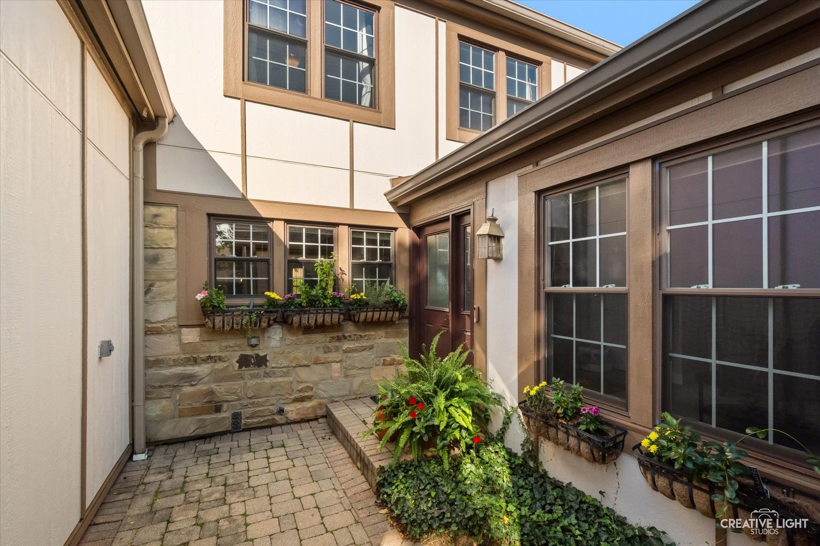 Welcome to this beautifully updated 4-bedroom home featuring 2 1/2 baths, a 2-car garage, and a finished basement, with thoughtful updates completed in 2024. The inviting, open layout connects the kitchen with granite counters to the family room, where a cozy fireplace creates the perfect spot to unwind or gather with friends and family. French doors lead to your private outdoor retreat, complete with a brick paver patio that is ideal for relaxing or dining al fresco. With multiple options for a dedicated home office, there's flexibility to fit your lifestyle. The spacious primary suite offers a full en-suite bath, while the finished basement provides additional living space along with plenty of room for storage.  Enjoy peace of mind with major updates, including the roof (2020), siding (2022), furnace and air conditioner (2024), refrigerator (2024), and a new sump pump with battery backup (2024). Located in a clubhouse community with year-round social gatherings and a pool, this home offers both comfort and a sense of community. The location is hard to beat, just blocks from Cosley Zoo and Wheaton Sports Center. A wonderful opportunity to enjoy updated living in a fantastic setting!