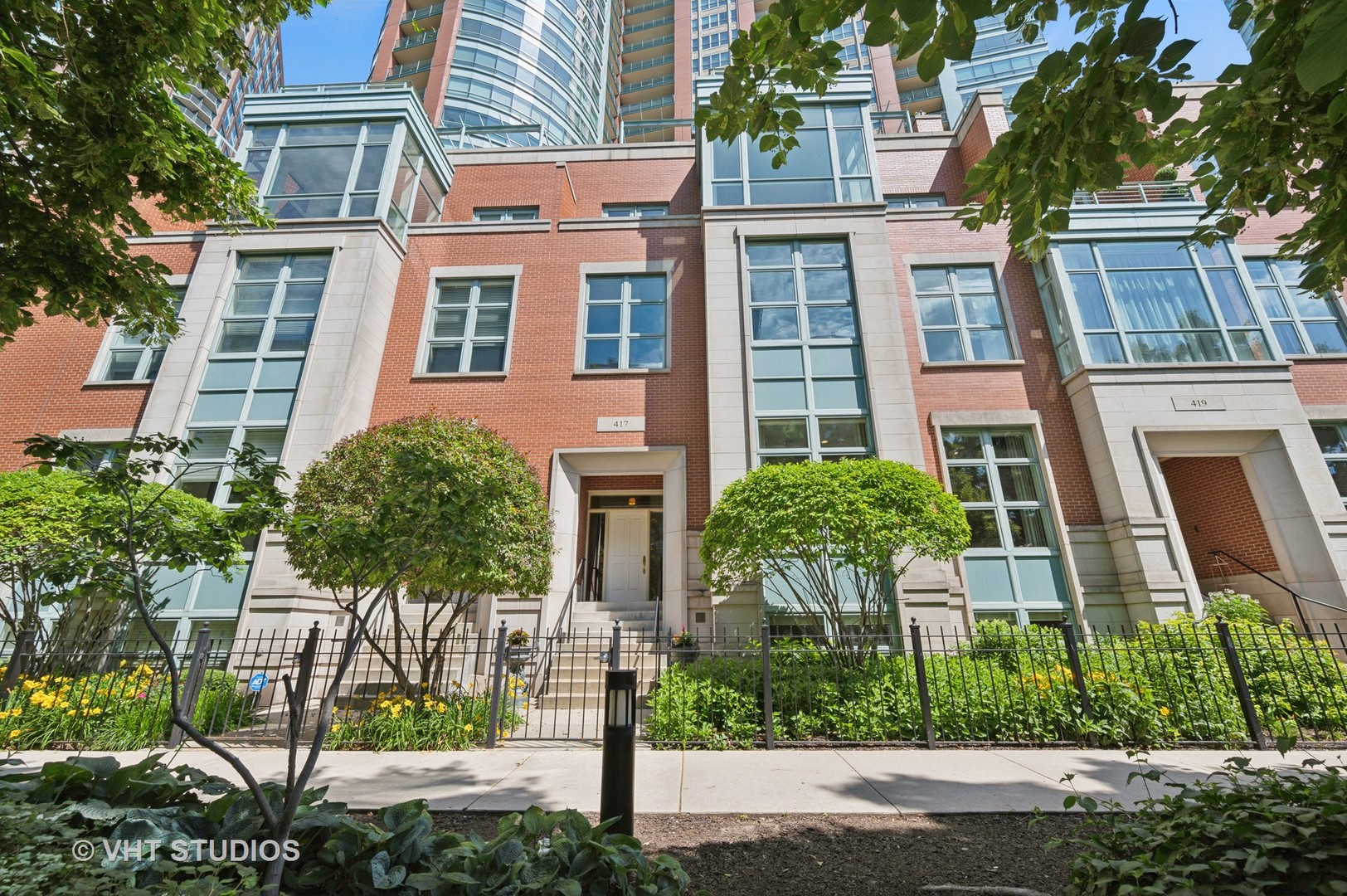 Luxurious Townhome on the Chicago River | Private 1060sf Rooftop Oasis + 2 additional terraces | Private Elevator!!  Featured in Crain's Magazine! Experience refined city living in this spectacular 4,434-square-foot townhome perched on the Chicago River, offering sweeping views of the river from every level with two balconies + an incredible 1060sf built-out private rooftop terrace with views of Lake Michigan & the Chicago River. This beautifully upgraded home features a private elevator, soaring 10-foot ceilings, oversized windows, and impeccable finishes, including solid-core doors, custom built-ins, and wide-plank hardwood floors.  A completely redesigned custom kitchen, completed in 2022, is the true heart of the home, designed to maximize river views and flow seamlessly into the entertaining spaces. Custom millwork, a walk-in pantry with built-in wine column and wet bar, and top-tier Wolf/Sub-Zero appliances elevate the experience. Highlights include a 48" professional fridge/freezer, steam oven, 6-burner range with hot water tap, Calcutta marble island and counters, and full-height backsplash and hood.  The expansive primary suite offers two custom walk-in closets and a spa-inspired bath. The third floor features two additional bedrooms, a den (easily converted into a fourth bedroom), two terraces, and ample living space. The top-floor rooftop deck is a fully built-out private sanctuary with a fireplace-your own outdoor oasis in the sky.  This townhome lives like a single-family home but has all the perks of a luxury building: 24-hour door staff, indoor pool, state-of-the-art fitness center, yoga studio, sundeck, dog run, business lounge, and more. Tucked away on a quiet, tree-lined street in Streeterville, you're just steps from parks, the Riverwalk, Ohio Street Beach, shopping, dining, and the water taxi.