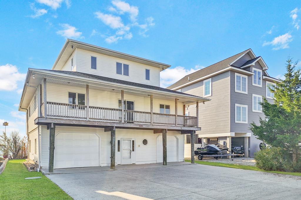 Discover waterfront living at its finest in this stunning four-bedroom, three-bathroom home that perfectly blends comfort with coastal charm. This beautifully updated property welcomes you with an open floor plan featuring brand-new luxury vinyl plank flooring that flows seamlessly throughout the main level, complemented by energy-efficient LED lighting and stylish ceiling fans.The heart of the home showcases a waterfront dining area where you can savor morning coffee while watching the sunrise over the water. The primary suite serves as your personal retreat, complete with direct access to a private waterfront deck, spacious walk-in closet, and updated bathroom featuring a new vanity. An additional bedroom and full bath complete the main level. Upstairs you will find 2 additional bedrooms