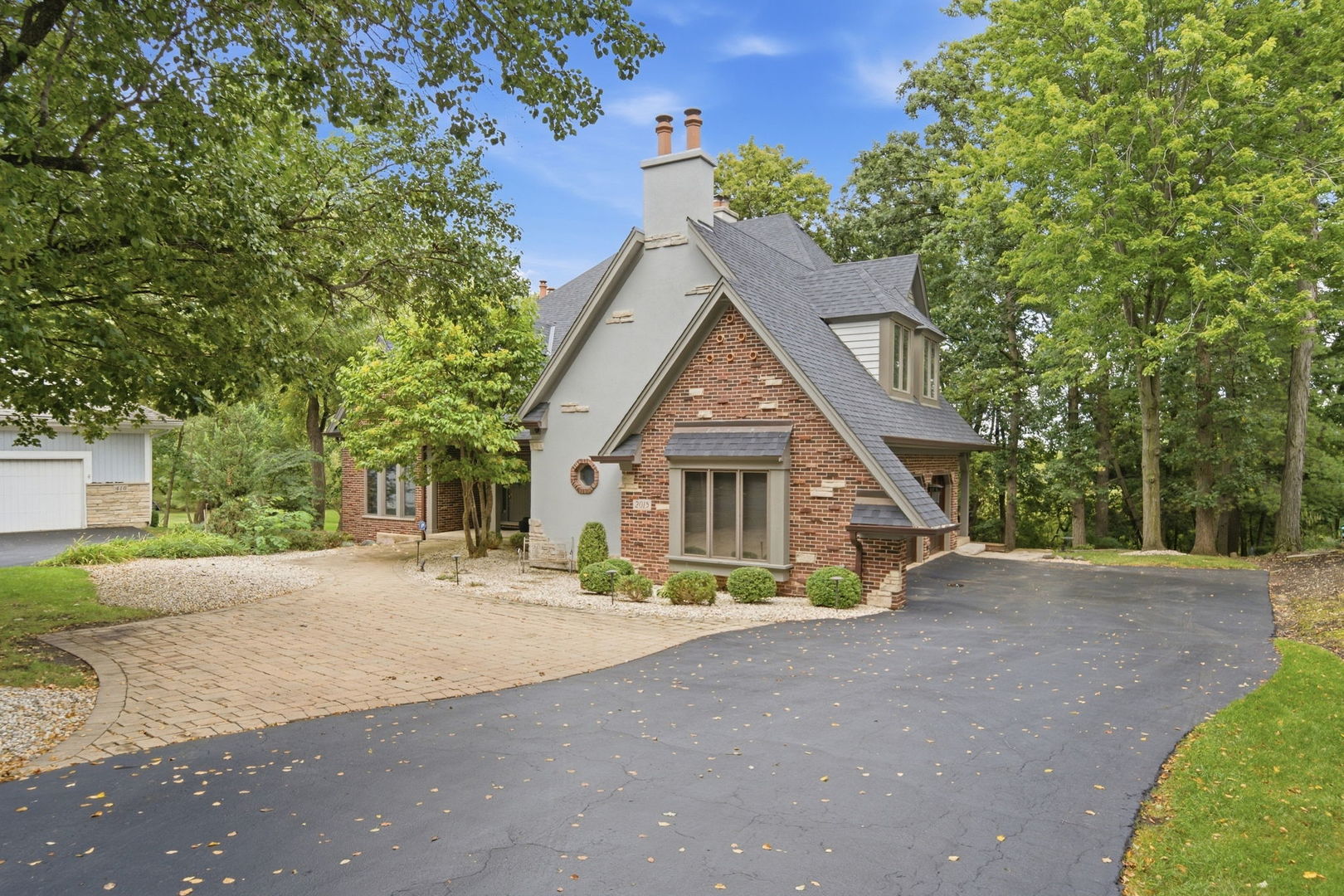 One of the few original STAN LEONARD CUSTOM BUILT homes set on a PREMIUM WOODED LOT backing up to the nature preserve in Dunhaven Woods. A natural retreat designed to relish the serenity of the trees. This 4 Bedroom, 4 1/2  Bath home boasts over 5300 square feet of quality craftmanship including a finished WALKOUT basement. This unique floor plan is great for entertaining. Welcome your guests into the impressive two story foyer. Beautiful quality woodwork, custom built ins, and hardwood floors throughout. The main level features ample living room that leads out to a huge deck that sits underneath the canopy of trees, formal dining room, formal sitting room, a sun room with heated floors, and a first floor library/office overlooking the preserve with private deck. 1/2 bath. The large cooks kitchen offers a huge island, granite counters, custom cabinetry, butler pantry and sun filled breakfast room with view of the preserve. 4 generously sized bedrooms and 3 remodeled baths on the 2nd floor. Two are on suite! Luxury primary suite with vaulted ceilings and skylights, fireplace, walk in closet and a beautifully remodeled spa bath with heated floors, dual vanity, spa shower and floating tub. Finished walkout lower level that boasts an extra-large recreation room with fireplace (a 5th bedroom could be easily added) full remodeled bath, wine cellar, large bar for entertaining and an office space. The quality and tranquility of this home can't be beat. The home has been very well maintained.  It features newer roof, siding, decks, water heaters, etc.   3 car garage. See home info sheet for more information.