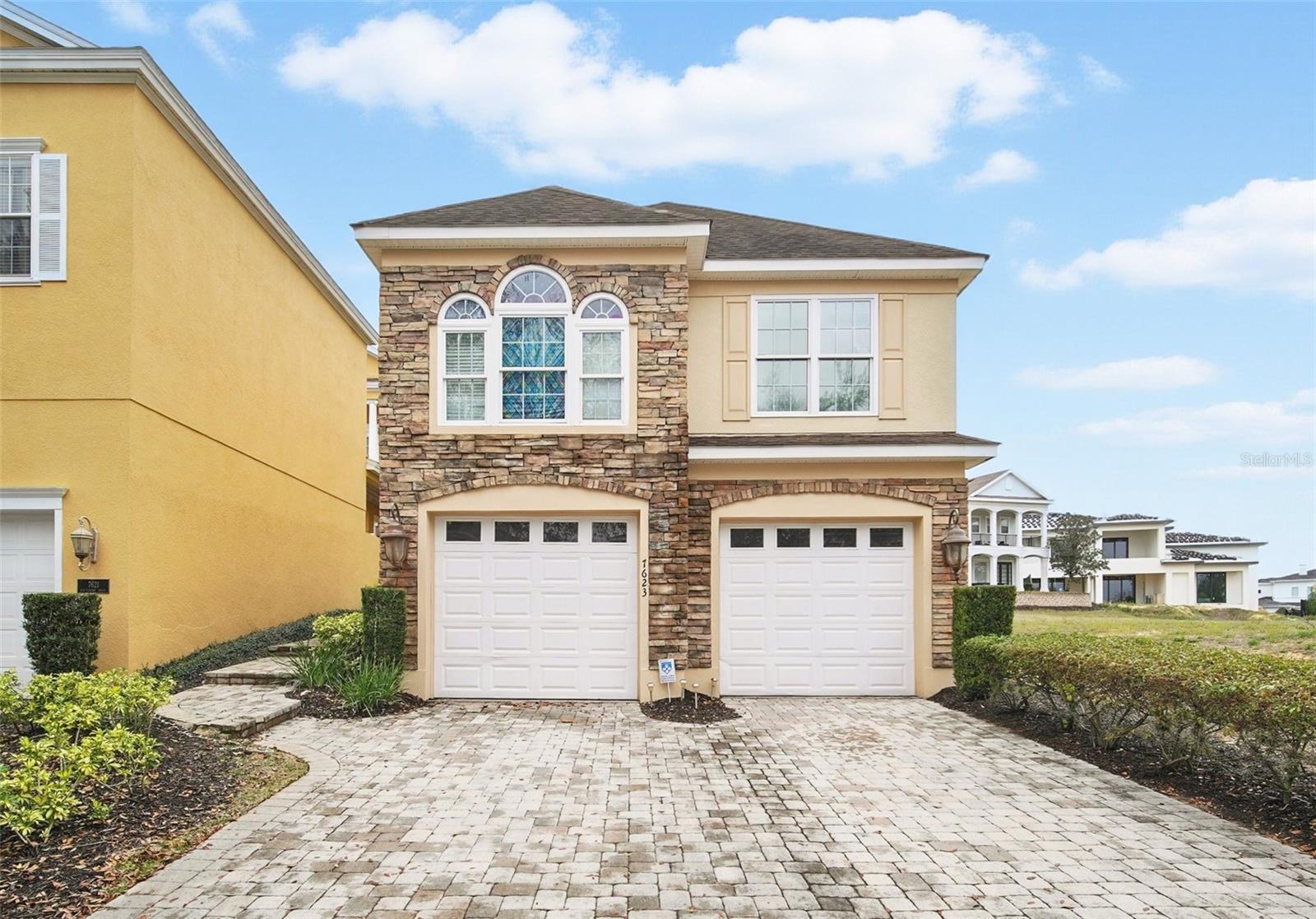 4 bedroom 4. 5 bath home located in the Liberty Bluff area of Reunion Resort. NO MEMBERSHIP. Brick paver parking pad, pavers leading up to the home and yard space between main home and garage features brick pavers and artificial grass. This is a great patio area for entertaining, afternoon bar-b-q's or room enough to add a pool! The front of the home has a beautiful brick facade. Upon entering the home you will find soaring ceilings, gorgeous kitchen with gas stove that flows into the eat-in dining area and living room. The primary bedroom is downstairs with two bedrooms upstairs, and spacious loft area that could be used as play area, fitness area or office space. Upon entering the home, you will find cherry wood hardwood floors. There is a 1-bedroom apartment over the garage. Does not have a kitchen space, only 1 bedroom, 1 bath and loft type area. Enjoy the many amenities of living in Reunion Resort, included gated community, 3 signature golf courses, 5-acre water park, tennis & a variety of dining options. Just minutes away from Disney and just a little over a hour away from the beaches and cruise ships! Live the REUNION Lifestyle!