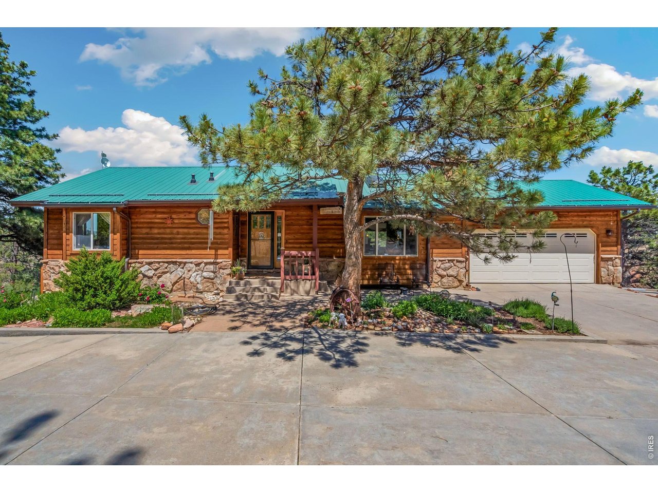Experience the unmatched lifestyle of Carter Lake living in this custom-built ranch tucked into a private 1.9-acre setting with breathtaking foothill, valley, and city light views. Surrounded by outdoor recreation including boating, fishing, hiking, paddle-boarding, and horseback riding, this property offers true Colorado living at its finest. Inside, you'll find warm custom craftsmanship throughout with copper and maple finishes, stunning woodwork, stone accents, cathedral vaulted ceilings, skylights, and an open floor plan designed to capture the incredible scenery from nearly every window. The kitchen features a 6-burner gas range, pantry, separate dining room, and abundant character. The spacious primary suite includes radiant heated floors, a walk-in closet, luxury bath features, and custom wood sink. The finished walkout basement offers 2 additional bedrooms, wet bar, projection TV area, pellet stove, and additional laundry hookups. Enjoy over 1,000 SF of private decking and patio space, hot tub, oversized garage, RV parking with electric, copper gutters, evergreen trees, stream surroundings, and superb landscaping. The impressive heated 1,120 SF shop/pole barn includes a car lift, finished bar area, carport, and RV electric. A rare opportunity to own a private retreat near one of Northern Colorado's most desirable recreational destinations.