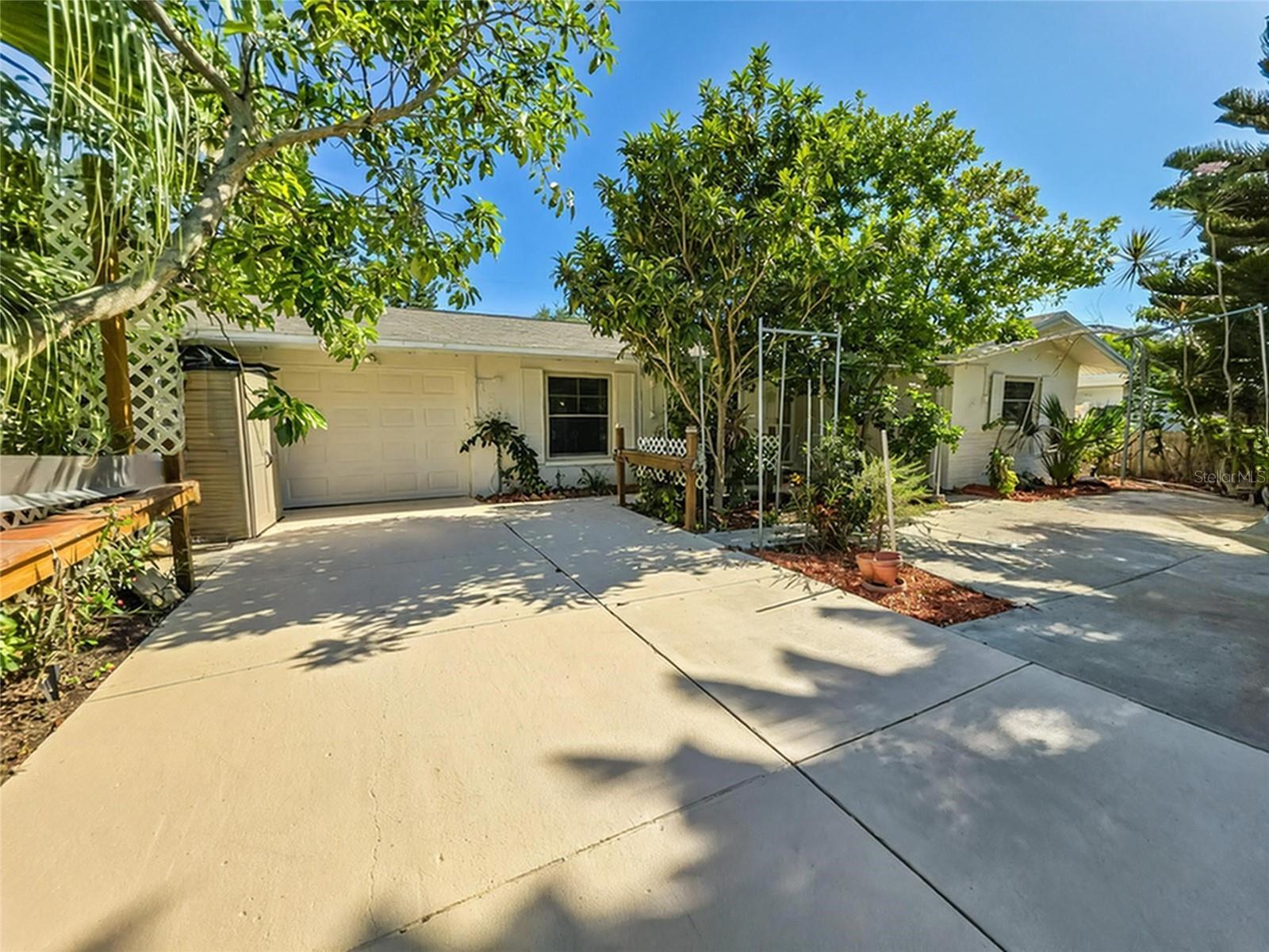 One or more photo(s) has been virtually staged. Welcome home to this Charming 3-bedroom, 2-bath POOL home with NO HOA! Enjoy the flexibility of ownership—this property allows rentals for as little as one month, making it perfect for extended vacations, seasonal living, or a fantastic income opportunity! Stepping inside, you’ll be greeted by a bright and open floor plan with a spacious living room. The kitchen features beautiful GRANITE countertops, ample prep and storage space, counter seating and opens to the dedicated dining space and living area. Gather in the either the Living Room or Family Room to enjoy your favorite movie or serene outside views. With three bedrooms and 2 UPDATED BATHROOMS, there’s ample room for everyone. Maintenance is fast and easy with NEW LUXURY VINYL PLANK FLOORING through the main living area. Enjoy a refreshing swim in the pool, or soak your cares away in the spa.  This home boasts energy efficient living with its OWNED SOLAR PANELS providing low electric bills & Propane Gas to Heat your pool. Lush landscaping surrounds the home and provides fruit trees and avocado tree. You’ll love being just minutes away from Clearwater Beach, shopping, dining, and all that Clearwater has to offer. Don’t wait—schedule your private showing today!