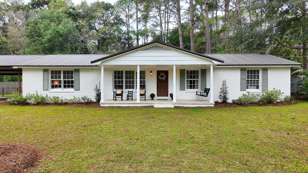 Nestled in the beloved Lakeside community, this 3-bedroom, 2-bath brick Ranch blends timeless charm with modern upgrades. Step inside and feel instantly at home!  We love all the freshly updated fixtures throughout and a remodeled master bath! In addition, the two versatile living areas give you space to work from home, host family game nights, or create the perfect kids' playroom. Durable LVP flooring flows throughout for easy maintenance. Thoughtful storage options include extra hall closets, handy outbuildings, and a massive mudroom that doubles as laundry and pantry space.  Sip your morning coffee on the screened porch, enjoy summer barbecues in the fully fenced backyard, and stay covered in any weather with a connected 2-car carport.  Warm, inviting, and full of character, this home is ready for you to call home. Give your favorite agent a call today to view!