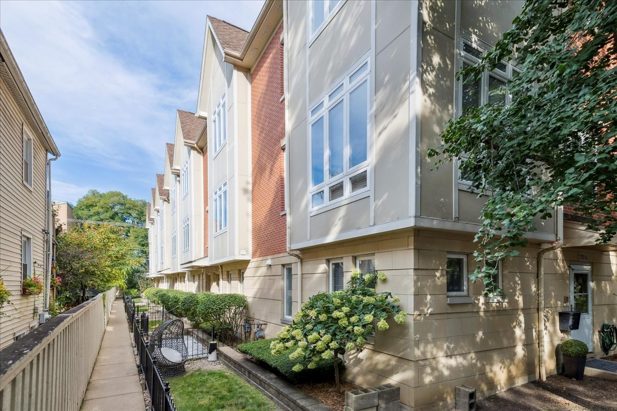 Welcome to this spacious 4-level townhome in the heart of Bucktown, offering 3 bedrooms, 2.5 baths, and a thoughtful floor plan designed for modern living. Tucked away with a quiet private entrance off Lister, the home opens to a generous family room on the ground level, complete with laundry and direct access to the attached 2-car garage.    The second level boasts an open-concept layout filled with natural light, soaring ceilings, and a striking custom fireplace with built-in shelving. The expansive living and dining space flows seamlessly into the updated chef's kitchen, featuring a massive island, stainless steel appliances, and direct access to a private balcony perfect for grilling or morning coffee.    Upstairs, the third level hosts two bedrooms, including a grand primary suite with a walk-in closet and a spa-like en suite bath with dual vanities, a large walk-in shower, and stylish finishes. A second bedroom and full bath complete this floor.    The fourth level offers incredible versatility ideal as a guest suite, office, or additional bedroom plus access to a private rooftop deck where you can unwind or entertain while taking in neighborhood views.    With multiple outdoor spaces, modern updates, and an unbeatable Bucktown location near restaurants, shopping, parks, and transportation, this townhome truly has it all.