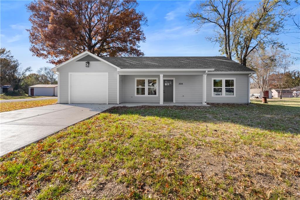 Welcome to this stunning new construction home offering 3 bedrooms, 2 bathrooms, and 1,376 square feet of modern comfort! Step inside to an open-concept layout featuring luxury vinyl plank flooring throughout, beautiful stained cabinets, granite countertops, and under-cabinet lighting. The custom closets add thoughtful storage and style. Enjoy outdoor living on the covered front and back porches, perfect for relaxing or entertaining. With a spacious 3-car garage, additional shop space, all-electric HVAC system, insulated fiberglass exterior doors, and energy-efficient vinyl windows, this home combines quality, efficiency, and charm—all on a desirable corner lot!