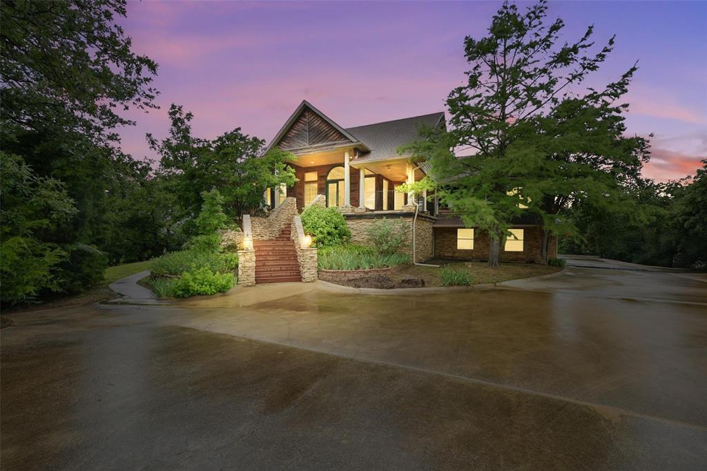 Incredible location in Emerald Sound, Lake Front Property on Lake Lewisville.  Incredible Potential, Priced Right for you to Update and Remodel it the way you would want your Perfect Lake House to be.  Four Bedroom, Five Bathroom Lake House on 2.2 acres, 5055 square feet, open floor plan with amazing views of the lake, large cedar deck, huge oak trees, and beautiful shore line.  From the moment you open the front door you are able to see the stunning lake views in all directions.  The living room has vaulted ceiling, wood burning fireplace, hardwood floors, an huge pictures windows with lake views.  The primary suite has a private door to the deck, his and her vanities and closets, laundry in the closet, jetted tub, and steam shower.  Guest suite has walk in closets, private bathroom and door to the outside deck as well.  The kitchen opens up into the living room and has a island and custom cabinets throughout. Highlights include, study with custom shelves, double stair case, large game and entertaining room, wood floors, custom cabinets and trim work throughout, and three car garage.  One of a kind lot and location! Great Layout!
