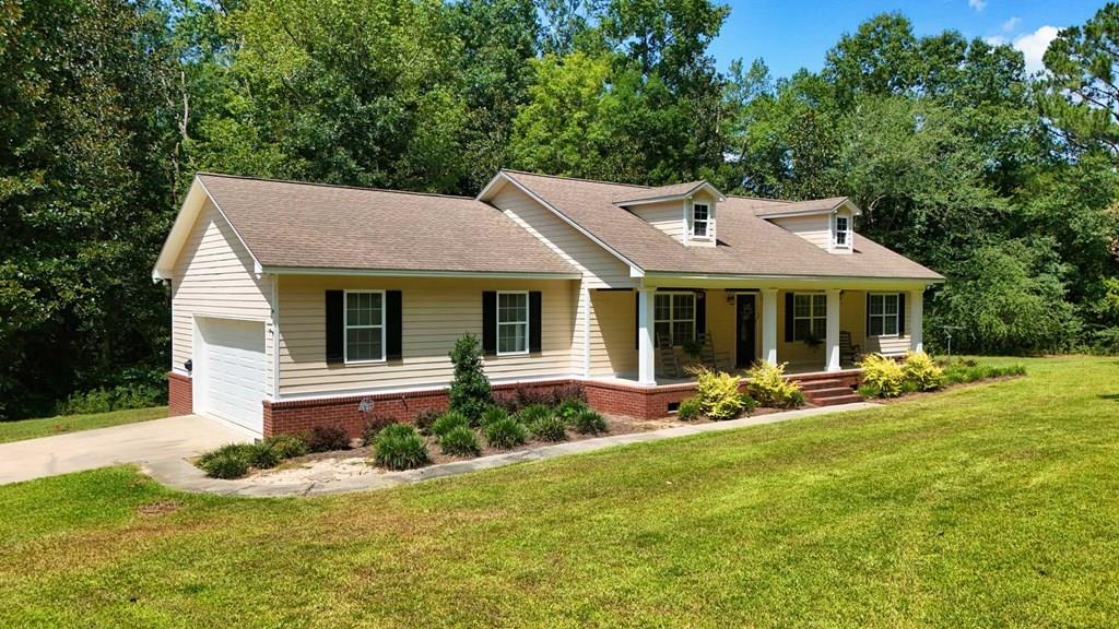 This home with is a beautiful country property situated on over 6 acres featuring a tranquil pond and a spacious 3-bedroom, 2-bath home with an open floorplan. The functional kitchen includes an eat-in island and ample counter space, flowing into a roomy living area ideal for relaxing or entertaining. The master suite offers a walk-in closet and private bath, while two additional bedrooms share a second full bathroom. Enjoy outdoor living with a generous deck off the dining area and a full-length rocking chair front porch. Additional features include a large laundry room, a 2-car garage, and plenty of room to expand. Centrally located with convenient access to Thomasville, downtown Cairo, and Tallahassee, this property blends privacy, comfort, and accessibility.