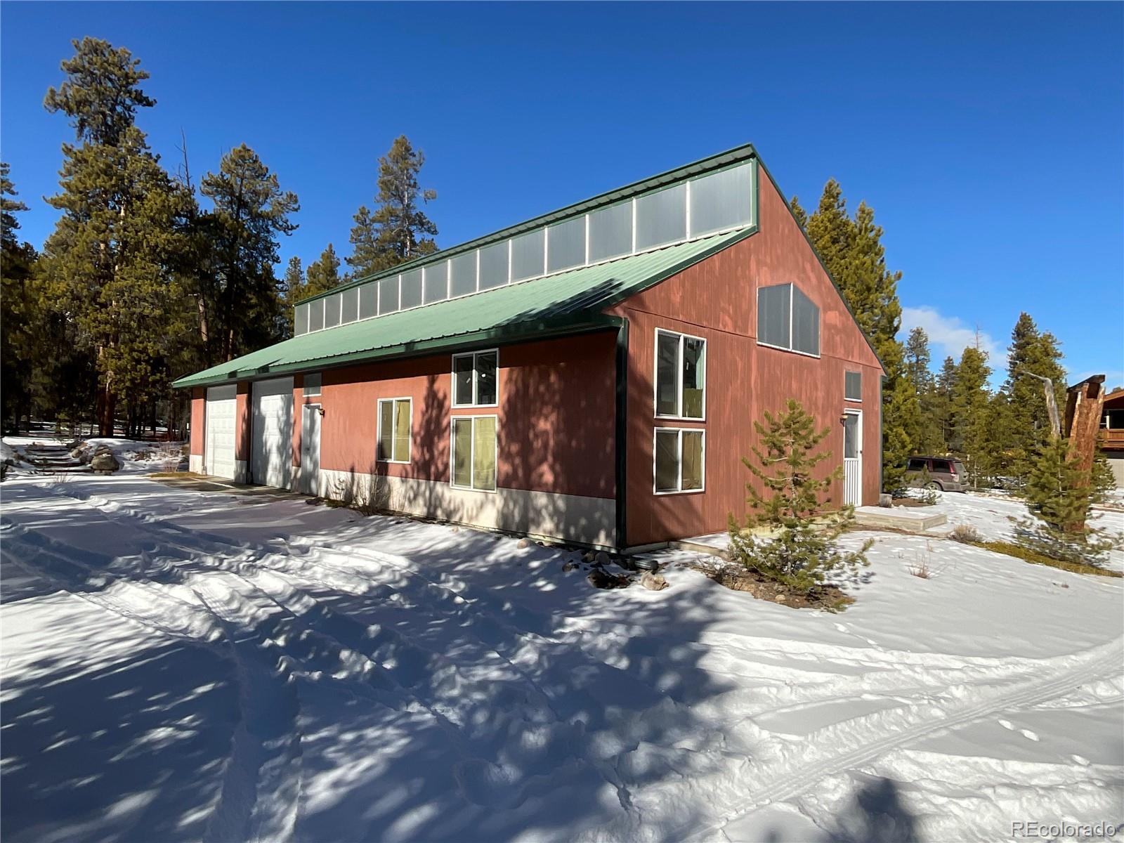 This beautiful, wooded 1.84 acre parcel features an impressive 1,800 sq. ft. garage. The excavation and concrete slab were done by Jack Saunders. The quality of construction is characterized by: steel beams, 6” studs, hardi-panel (non-combustible boards), and clerestory panels (made of triple polygal) which run the length of the roof ridge to provide natural lighting and a bit of warmth. There are 2 garage doors (10 feet tall) for vehicle entry. The roof snow load is 90#. There is a triple wall chimney in-place so a future owner can install a wood-burning stove. The sale also includes a current water certificate ($17,500 value) for the shared community well that serves the Pan Ark neighborhood. The garage does not have gas, electric, water or septic but this garage / workshop would be a dream for someone who needs space for storing: snowmobiles / classic cars / motorcycles / ATVs, etc. The garage was approved by the Lake County Building and Planning Department at the time of construction. Metro district is responsible for snowplowing. Info on water with fees can be found at: https://www.mountelbertwater.org/. Build your future dream home on this large, attractive piece of Twin Lakes real estate.