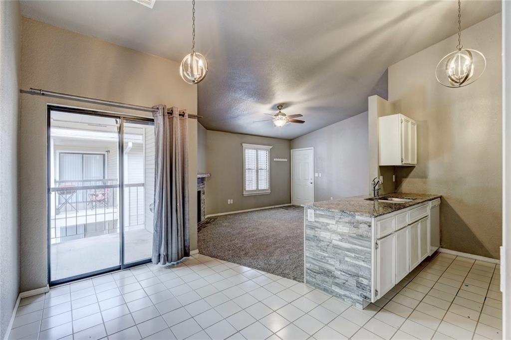Discover comfort and convenience in this updated 2-bedroom, 2-bathroom second-floor condo in the heart of Norman, just steps from the University of Oklahoma, Sam Noble Museum, and OU's athletic fields. Nestled in a gated courtyard setting, this upper-level unit offers a thoughtfully designed split-bedroom layout that balances privacy and functionality. Inside, you’ll find neutral colored carpet and paint throughout along with modern lighting fixtures. The kitchen is equipped with stainless steel appliances, granite countertops, and ample cabinet space—perfect for everyday living or entertaining. A cozy wood-burning fireplace anchors the spacious living area, while plantation shutters add charm and control light throughout the home. The primary suite features a generous walk-in closet and an en-suite bath with updated vanity and countertop. Step outside to a private, covered balcony. This unit includes two assigned parking spots (one covered, one uncovered) and the condo complex is near the OU CART Apartment Loop N32 stop for easy commuting. Whether you're searching for a primary residence, game-day getaway, or a low-maintenance investment, this move-in-ready condo checks all the boxes in one of Norman’s most desirable locations.