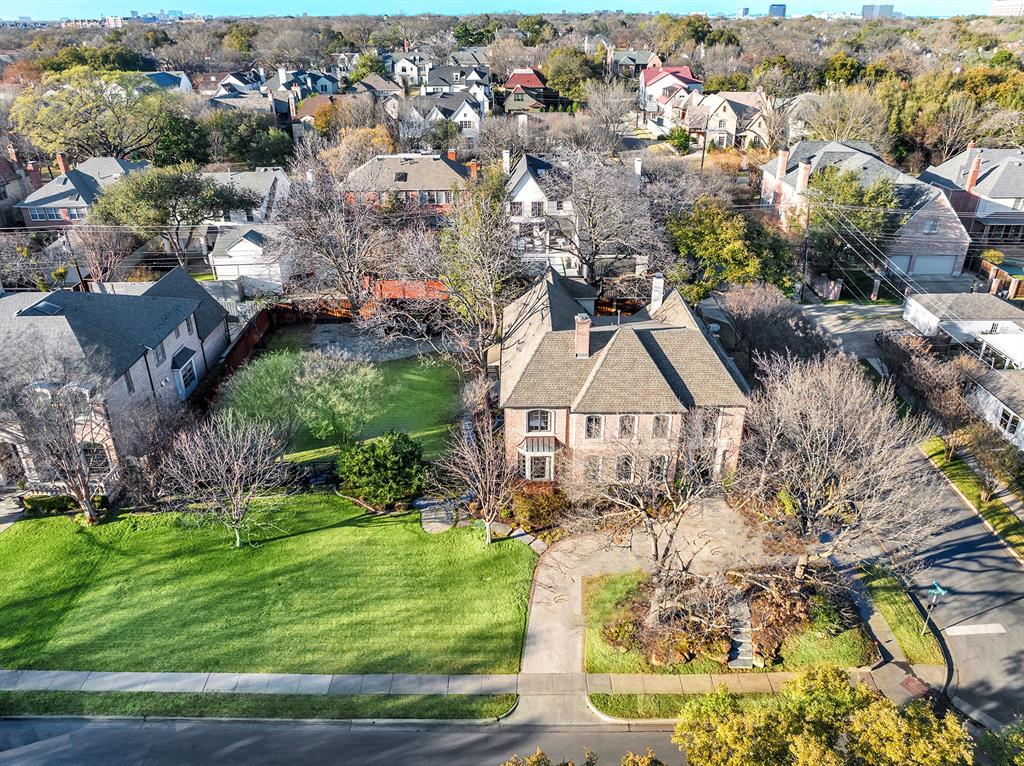 A rare double-lot opportunity in one of the nation’s most coveted neighborhoods, this exceptional University Park property presents a compelling combination of architectural refinement and extraordinary land value. It pairs a beautifully renovated residence at 3100 Purdue with the adjoining parcel at 3104 Purdue—two 70' x 144' lots totaling an impressive 140 feet of frontage—fenced and landscaped to create a single, expansive estate, further enhanced by its position on the quiet corner of Durham Drive, offering the additional benefit of privacy from neighboring homes on both sides.The separate parcel at 3104 Purdue introduces a level of optionality seldom found in the Park Cities. Currently enjoyed as a sports-field-sized lawn, the site readily accommodates a future guest residence, resort-style pool, sport court or walking garden. Or it may simply be preserved to maintain the remarkable sense of privacy and open space.Behind a gracious façade, the home itself reveals a refined transitional renovation by Kerry Ketner, where timeless architecture meets modernized interiors. With a dedicated office and 5 generous bedrooms with en-suite baths, it offers comfort and seclusion for family and guests. A series of elegant living spaces and a formal dining room flow effortlessly into an open kitchen and breakfast area designed for daily living as much as gracious entertaining. Expansive windows frame the verdant grounds and draw natural light throughout the interiors, while the home’s orientation toward the adjacent parcel creates a seamless visual and spatial dialogue between indoor living and the extraordinary grounds beyond.Situated within the prestigious Highland Park Independent School District and zoned to Boone Elementary School, the property offers exceptional lifestyle appeal and enduring long-term value. Just moments away, boutiques and restaurants of Snider Plaza and Caruth Park provide the walkable charm and community character that define the Park Cities.